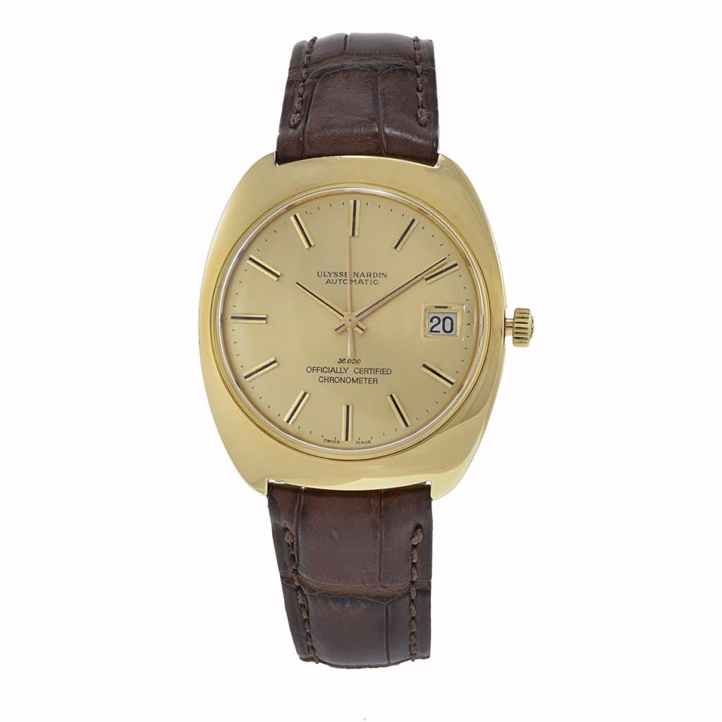 This Ulysse Nardin timepiece from the 1970s features a distinctive 39mm barrel-shaped case made of solid 18Kt gold, exuding vintage charm. Powered by an 36000 bph high beat automatic movement, it includes a date complication and is certified as a