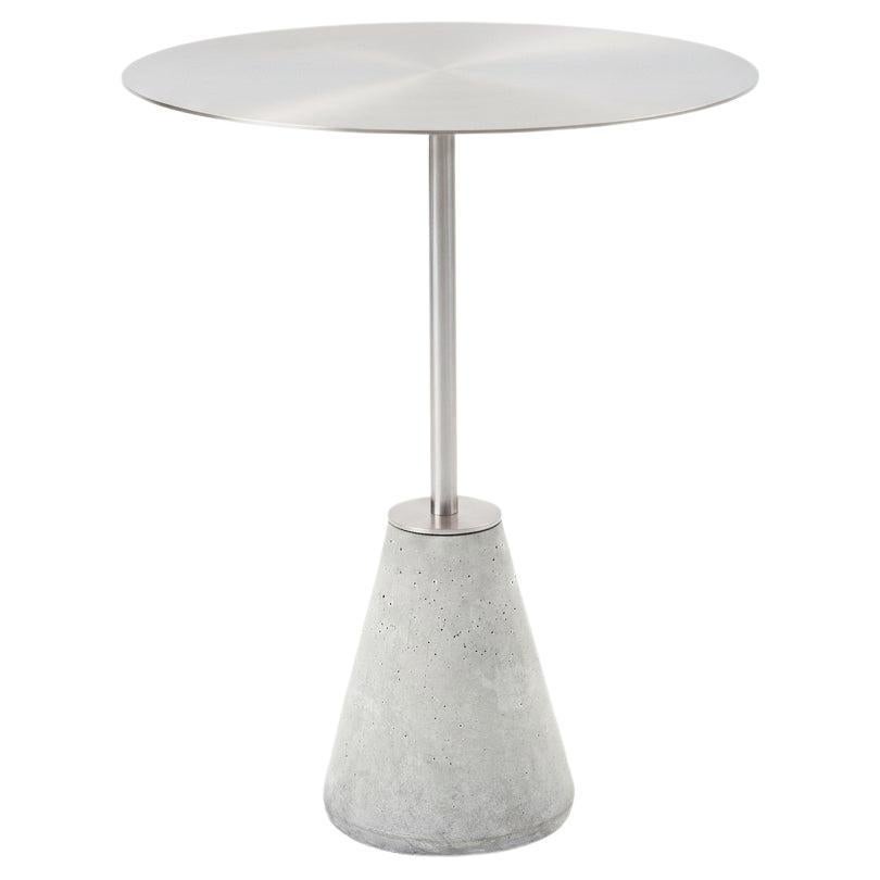 UM minimalist and contemporary bistro table in stainless steel and concrete.