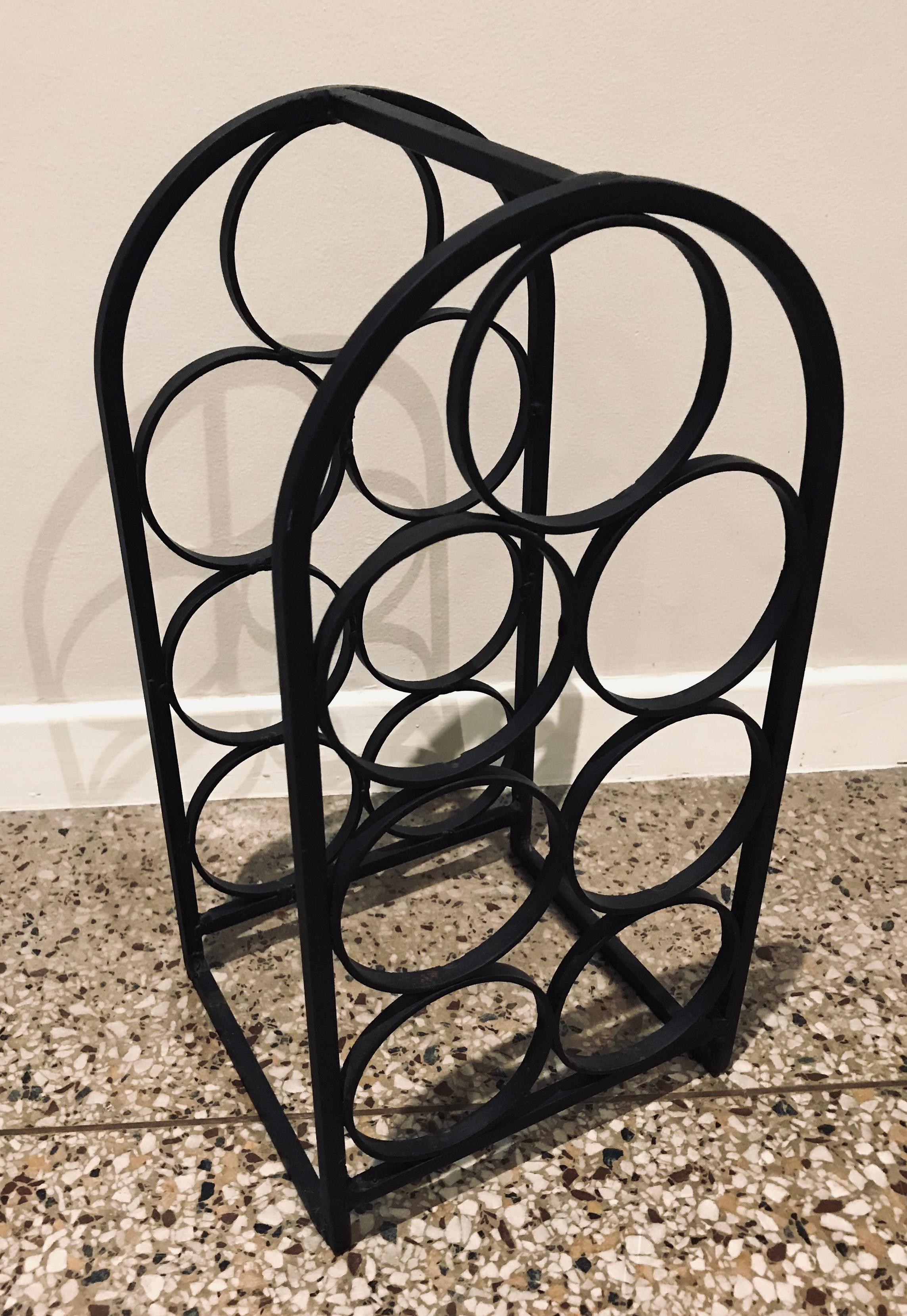 Small wrought iron wine rack designed by Arthur Umanoff for Shaver Howard and distributed by Raymor. 