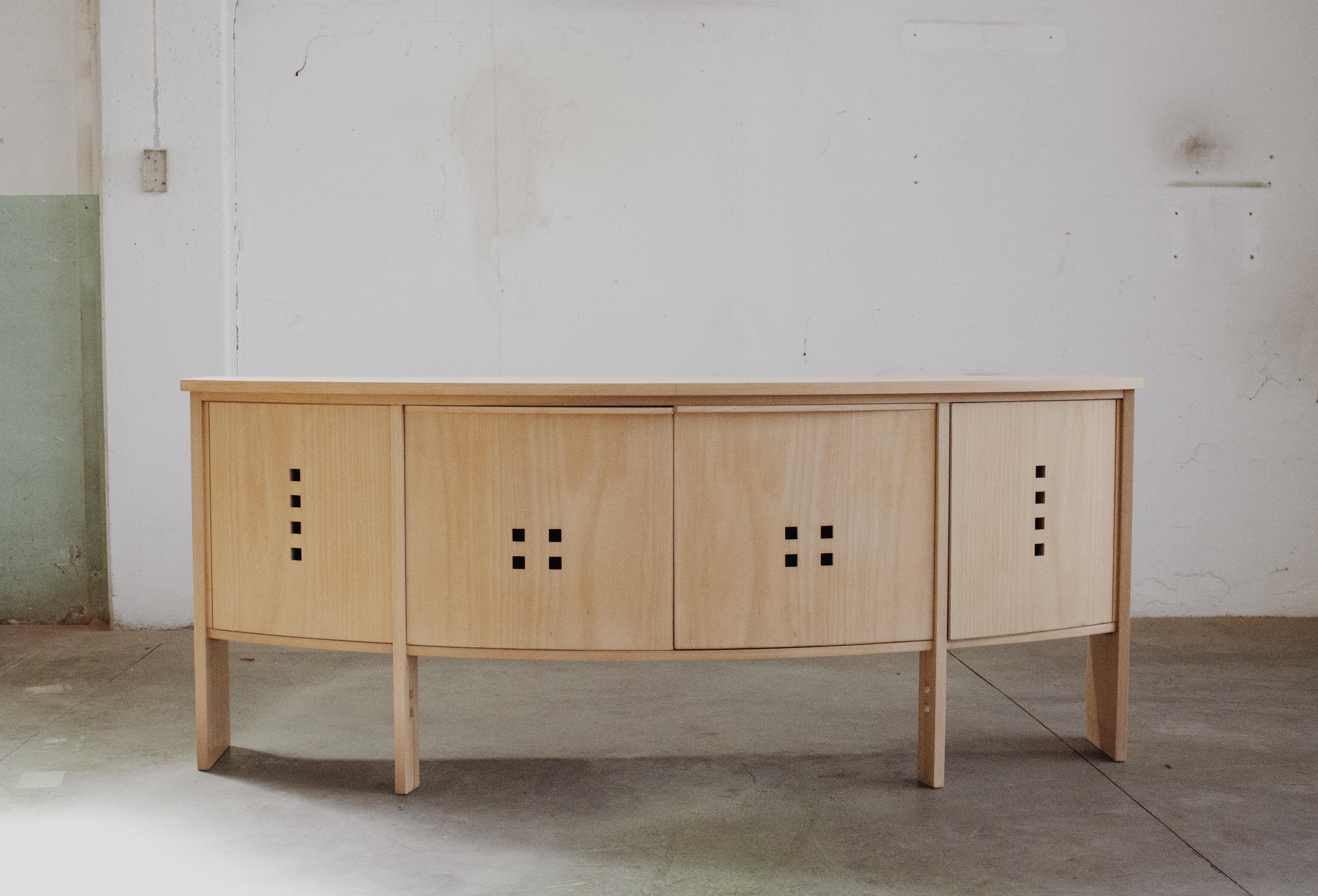 Umberto Asnago modernist wooden sideboard for Giorgetti, wood, Italy, 1987.

This sideboard shows the vital characteristics of the Italian designer Umberto Asnago. The base has narrow vertical legs and provides a floating appearance to the storage