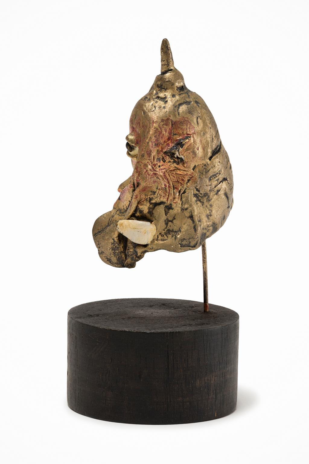 This small metal statuette exemplifies the Italian artist Umberto Del Negro's interest in playing with the themes of civilization and nature. From multiple angles this piece could appear to be an old world military helmet or one of the stranger
