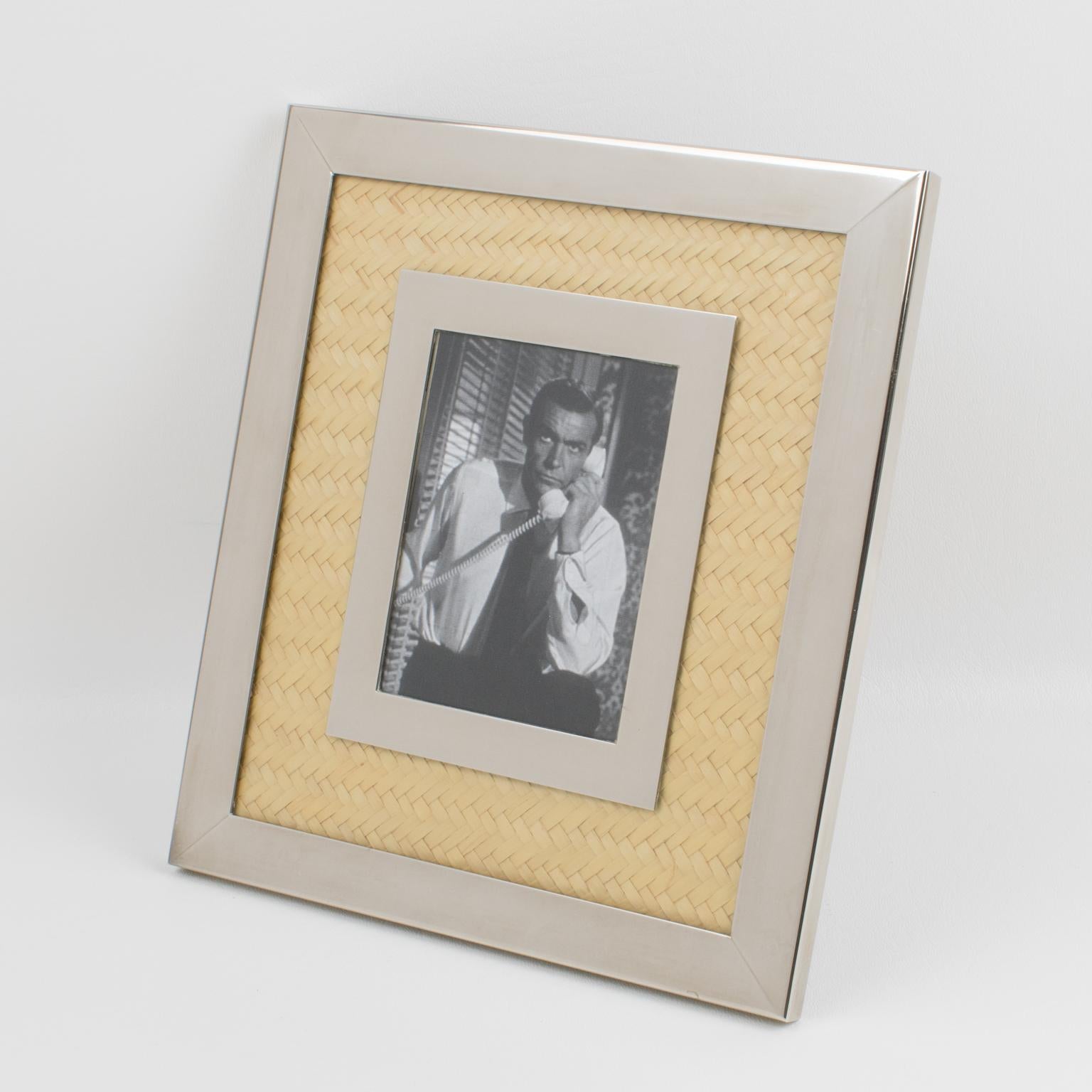 The company Umberto Mascagni, Italy, designed this elegant picture photo frame in the 1970s. The piece boasts chromed metal and straw marquetry combinations. The metal easel at the back has a rotating system that allows the frame to be placed in a