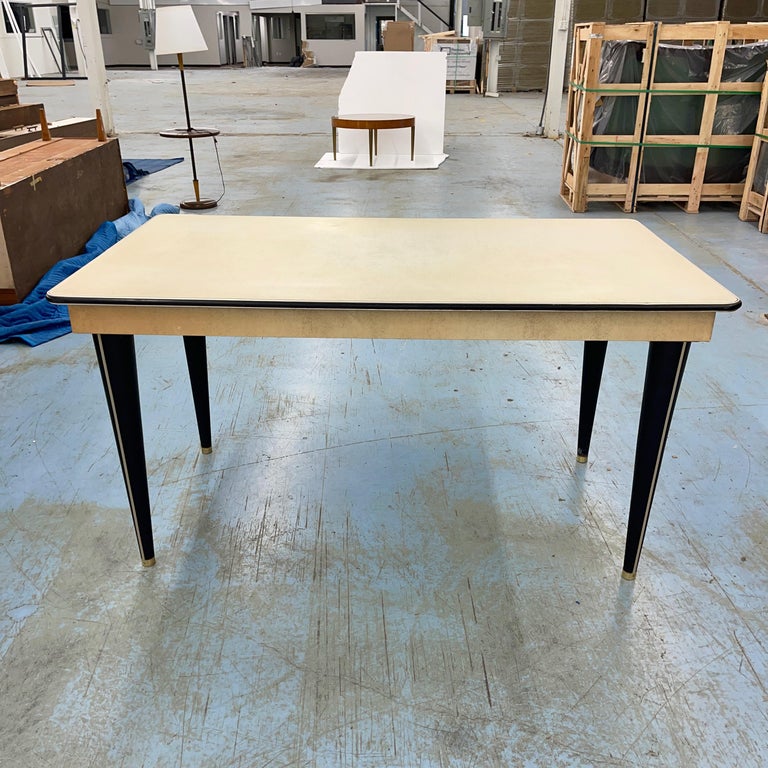 Handsome Italian modern dining table produced in Italy mid-1950's. by Umberto Mascagni of Bologna and imported to the UK by I. Barget Ltd. then retailed through Harrods among other stores.
Table top covered in skai, a then new material, similar to