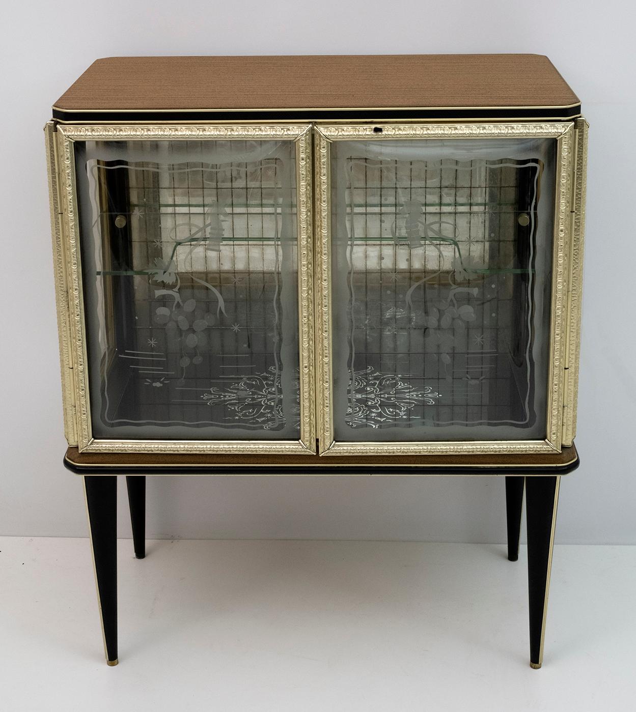 Bar cabinet designed by Umberto Mascagni of Bologna in the 1950s. The main structure is made of solid European wood, covered in cream-colored vinyl with anodized aluminum, decorated sanded convex glasses. Even the legs are covered with black vinyl!