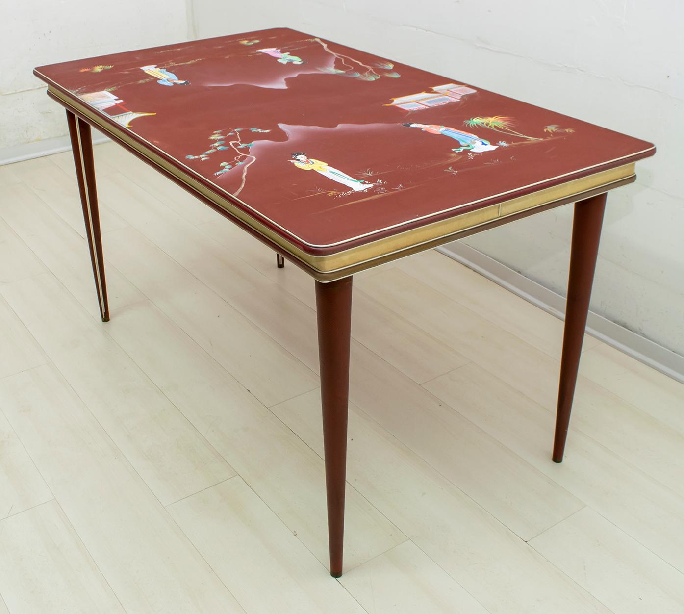 Dining table designed by Umberto Mascagni of Bologna in the 1950s. The structure of the main body is in European solid wood, covered in red and ivory-colored vinyl, with anodized aluminum, the top is covered with hand painted canvas fabric with