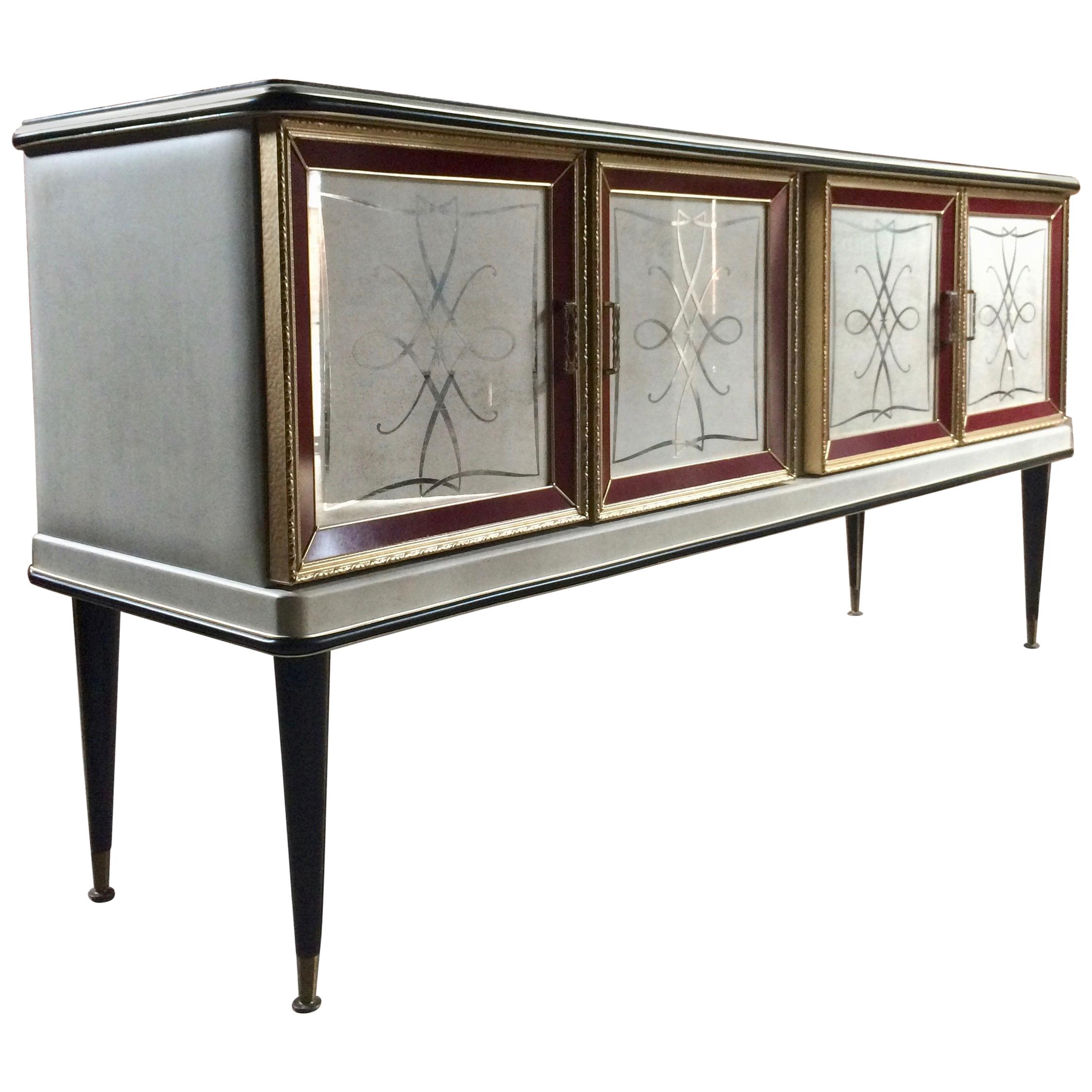 Magnificent Umberto Mascagni 1950s Italian sideboard credenza drinks cabinet, with a long rectangular glass top over four reverse painted glass fronted doors, one bay holding four free running drawers, another bay for bottles and larger items and