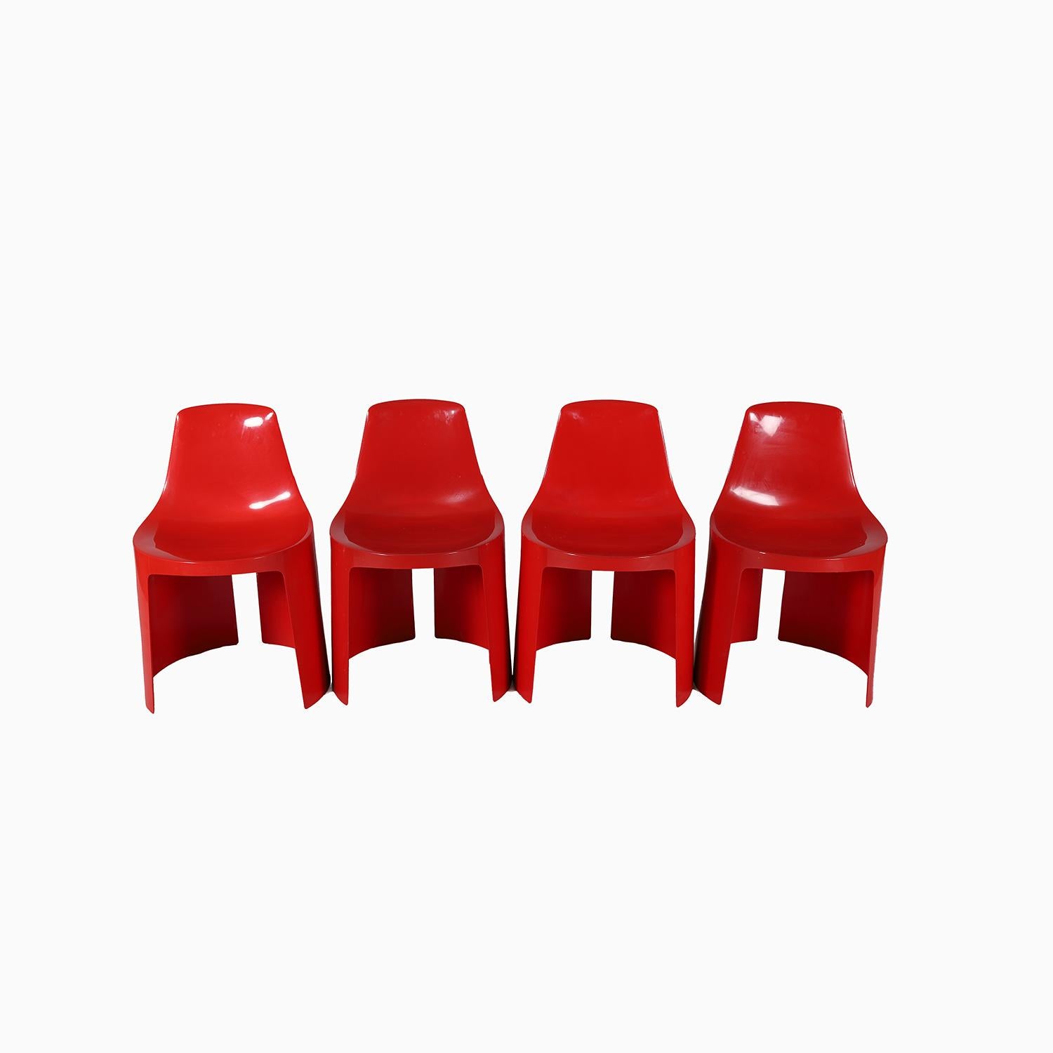 A set of 4 shiny molded plastic chairs in bright red.  Designed and produced in the mid- 20th Century by Umbo, designed by kay ReRoy Ruggles.  a cheery and space saving addition to any space.  Need a pop of color?  Look no further.  Excellent