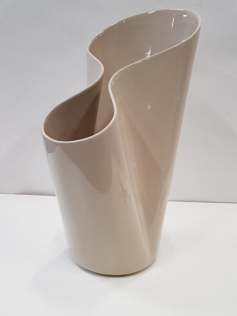 Umbravase, a Ceramic Umbrella Stand or Vase for Bosa (Italy) by Luca Nichetto.
The encircling shape of the Umbravase enfolds the flowers in a loving embrace. If required it can also be used as an elegant umbrella stand. 
Glossy grey.
 