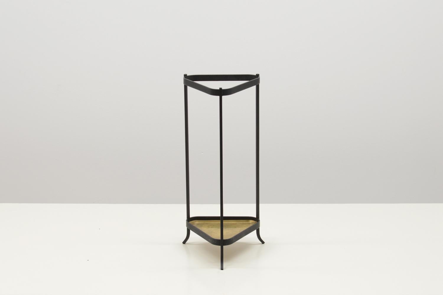 Umbrella stand by Gunnar Ander for Ystad metall, Sweden 50s. Black wrought iron base and brass dripping tray. Wear of use on the dripping tray, overall in very good vintage condition. 

 