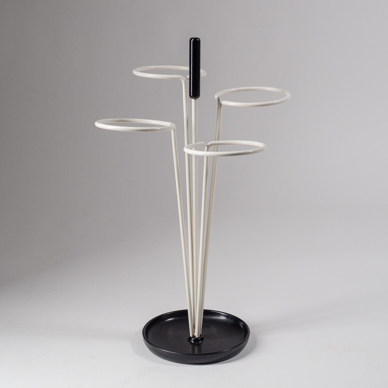 Fine graphical umbrella stand from the 1960s. Minimalist black and white enameled steel structure with a weighted base. Very good original condition with just minor wear.