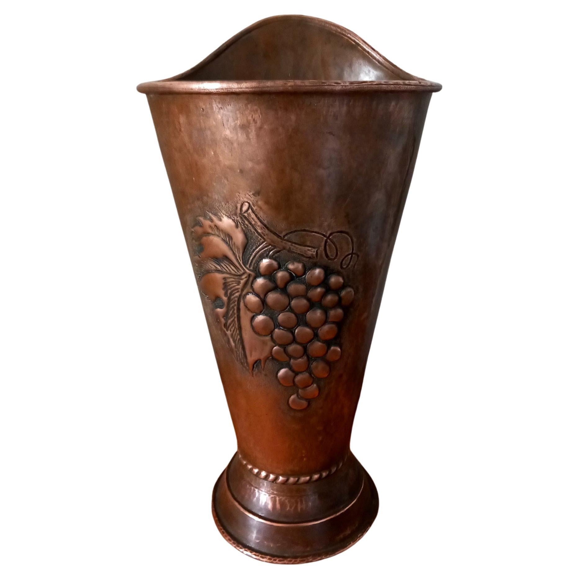 Beautiful solid copper umbrella stand. It is made with thick hammered copper and with a central bunch of grapes design embossed in the copper.

 Beautiful umbrella stand to put at the entrance of your house. It is discreet but at the same time
