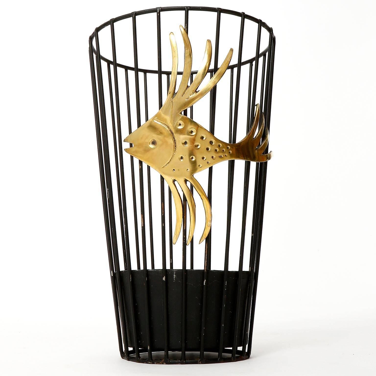 A beautiful umbrella stand by Walter Bosse, Vienna, manufactured in midcentury in circa 1950.
It is made of a black painted metal base and a polished brass goldfish with nice patina.