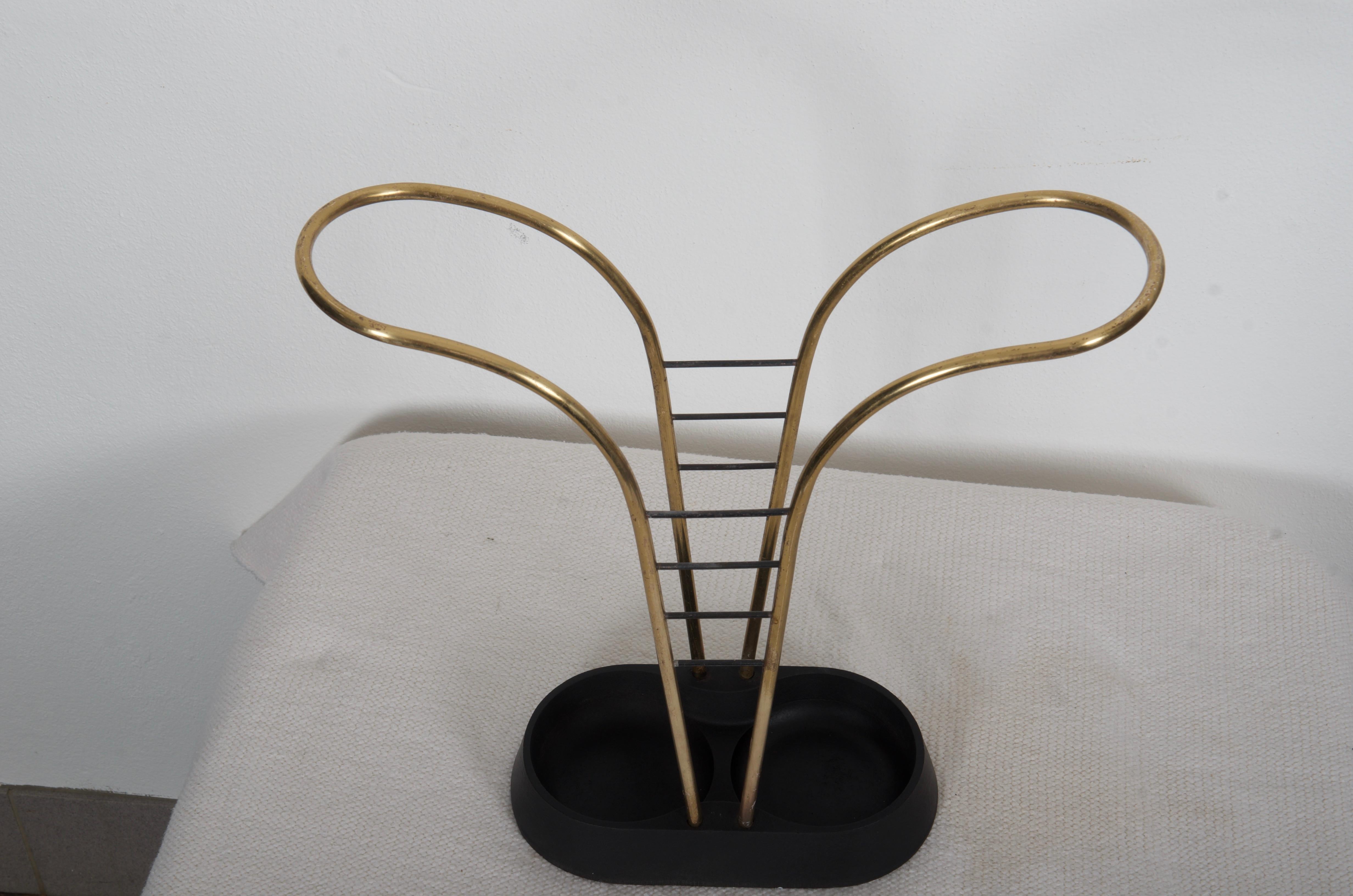 Cast iron foot with brass umbrella holder.