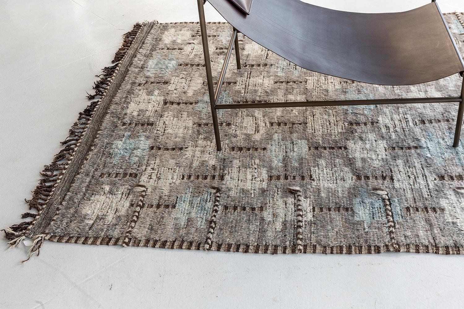 The 'Umea' rug is a handwoven wool piece inspired by vintage Scandinavian design elements and recreated for the modern design world. The rug's shag balance and harmony, handwoven with a neutral flat-weave and unique piles of taupe and orange spice.