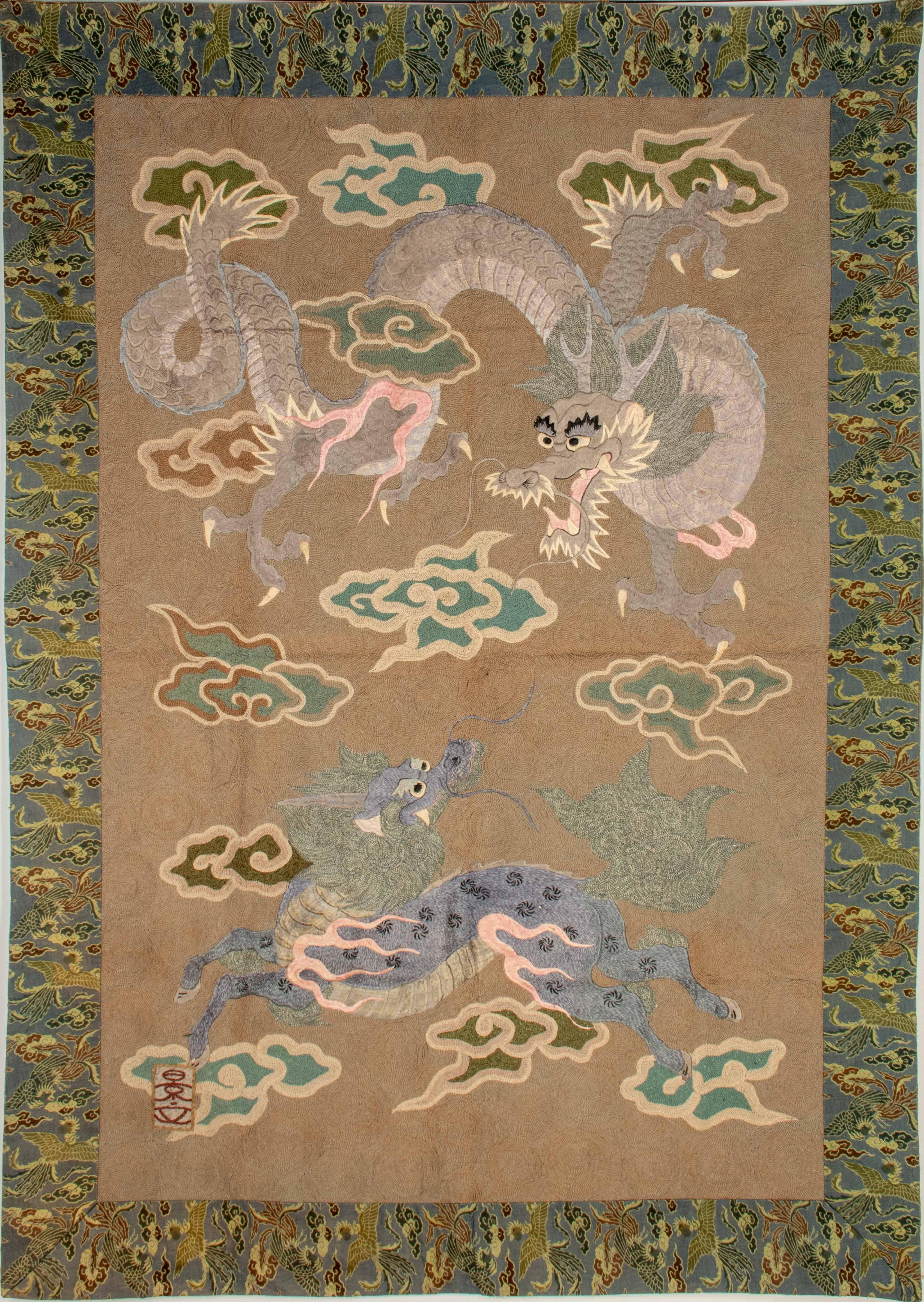 Tapisserie en relief en soie brodée représentant un dragon et un kirin dans les nuages.

Tapisserie en soie brodée en relief avec des fils polychromes, représentant deux figures mythologiques : un dragon ryū et un kirin se faisant face au milieu de