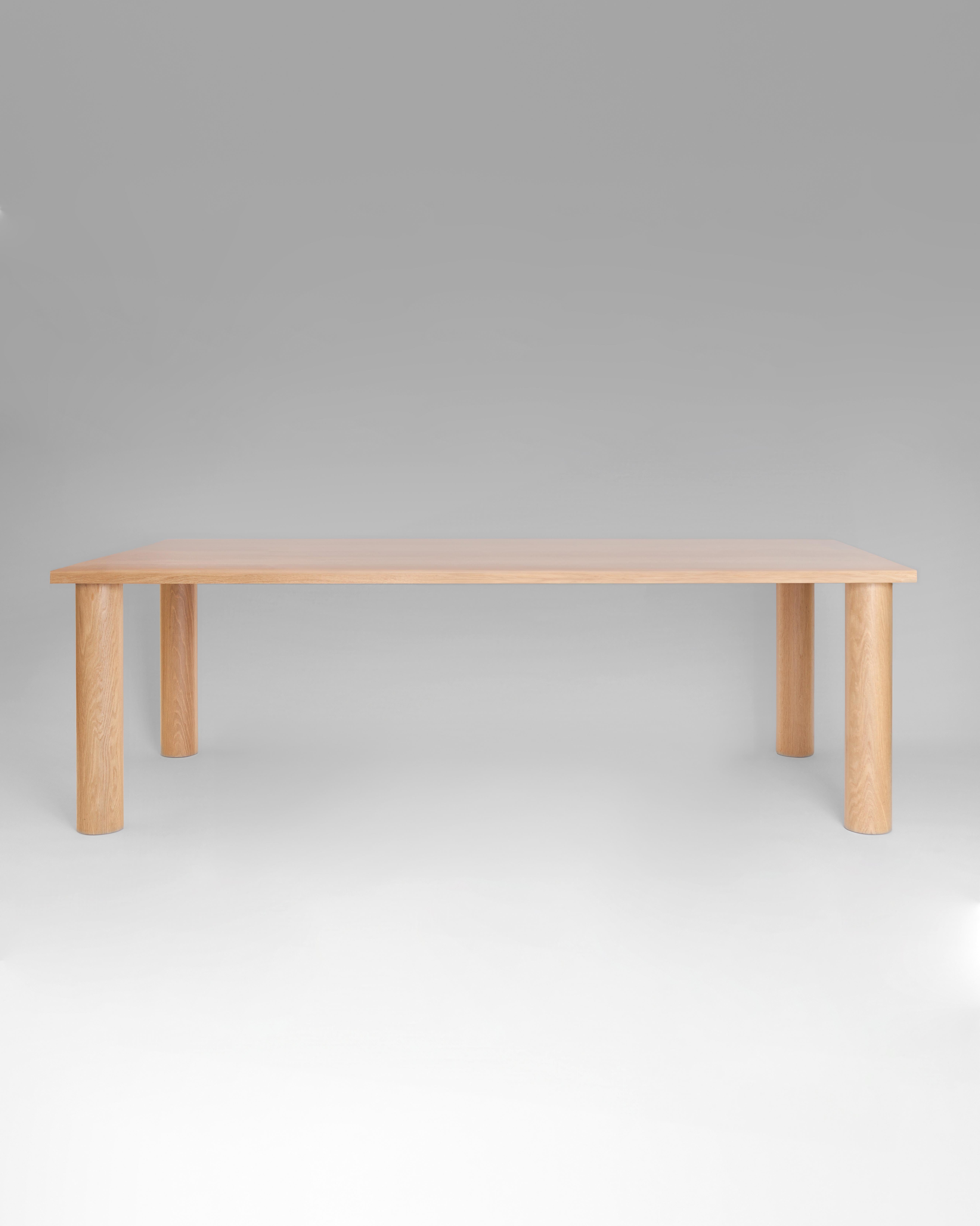 Crafted from solid wood, the UNA dining table offers a refined yet substantial form. Its clean lines and cylindrical legs create an understated yet elegant presence. Customizations available upon request
Shown in White Oak. Also available in Walnut