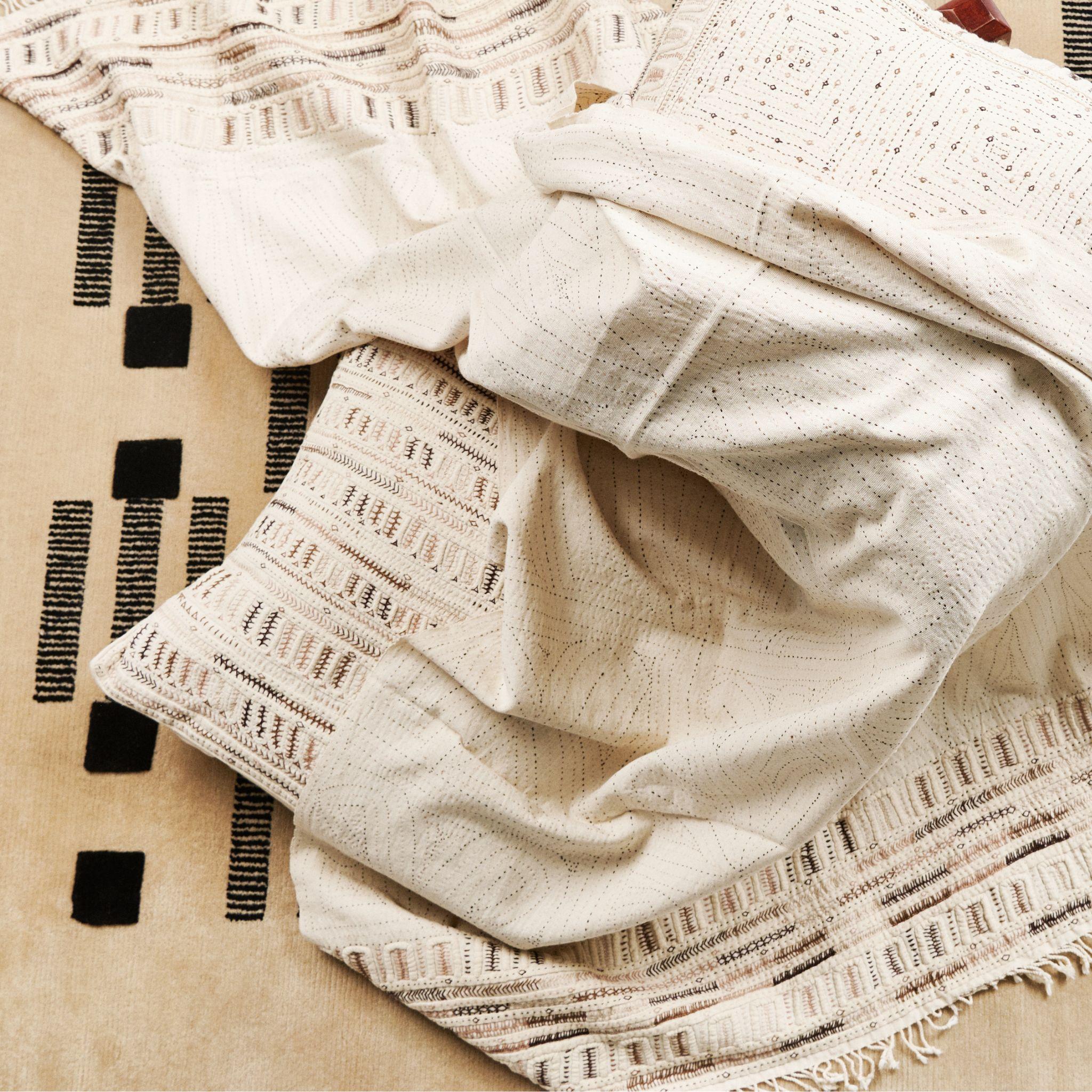 Unah is a fully embroidered throw, with one of a kind beautiful handwork highlighting the borders in colorful tones. Behind this piece is a unique group of artisan women in India. This particular technique is unique only to this particular cluster