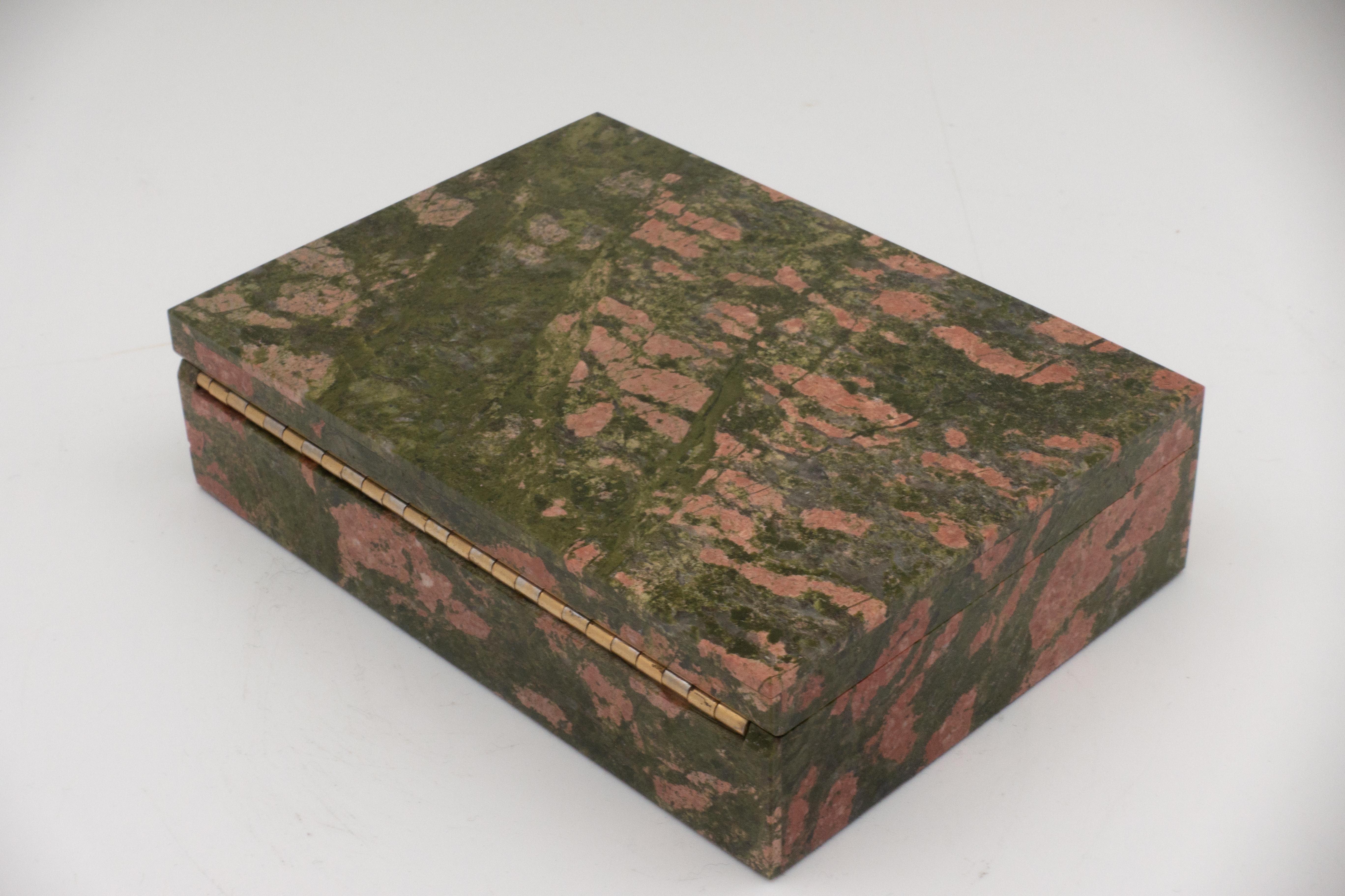 Unakite box with hinged lid. Unakite is an altered granite composed of pink orthoclase feldspar, green epidote, and generally colorless quartz. It was first discovered in the United States in the Unakas Mountains of North Carolina from which it gets