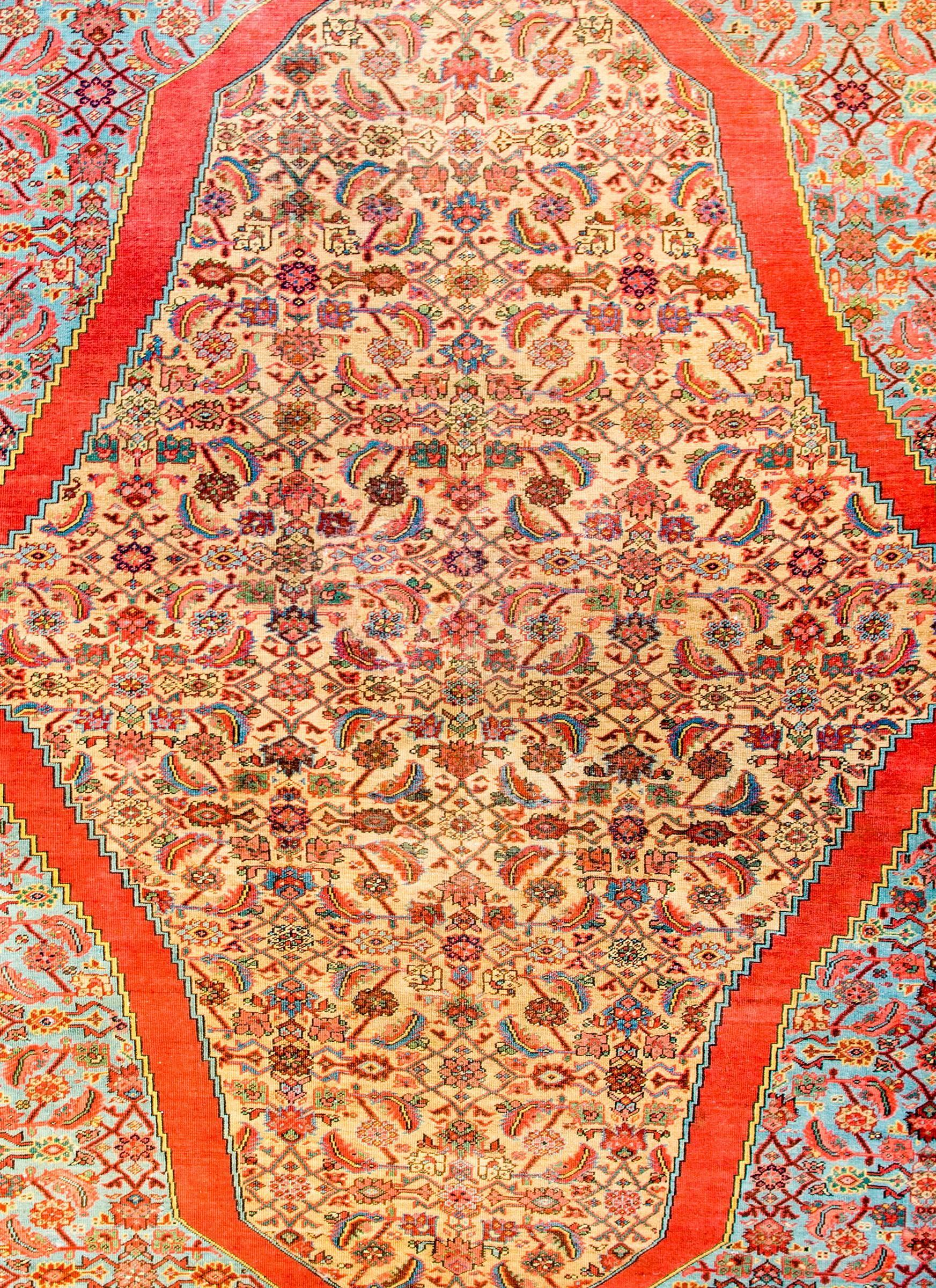 An unbelievable early 20th century Persian Bakshaish rug with an incredibly all-over trellis and floral pattern woven in crimson, pink, green, gold and dark indigo on a natural undyed wool background. The trellis floats in a large, wide crimson