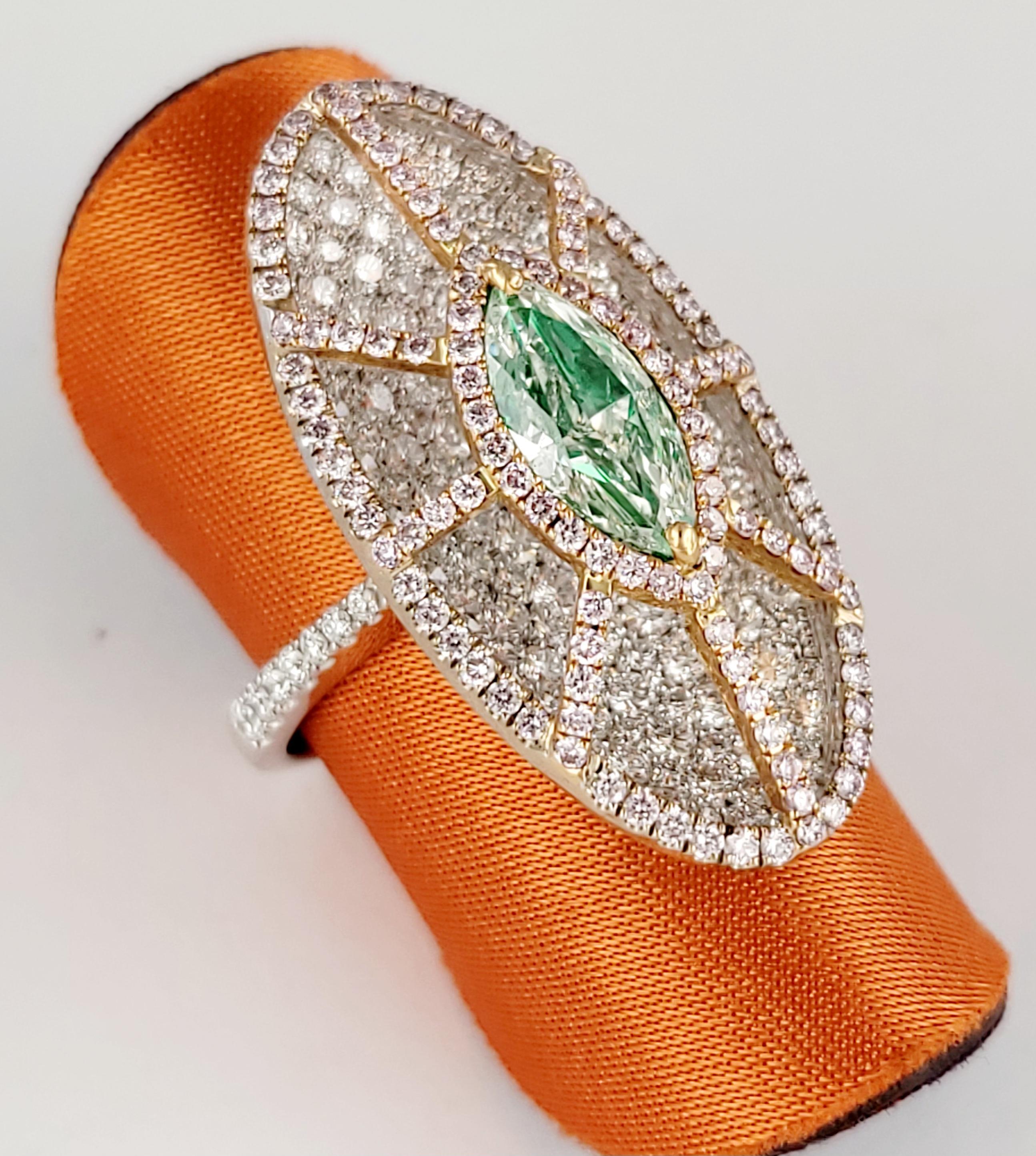 Unbranded Ring with Brilliants
Material: 18K White Gold 
Shape: Marquise Modified Brilliant 
Center Brilliant Clarity:SI1
Color: Natural, fancy Light Yellow Green, Even
Measurement: 10.31 x 4.85 x 3.05 mm
Carat Weight: 1.01 carat 
Side