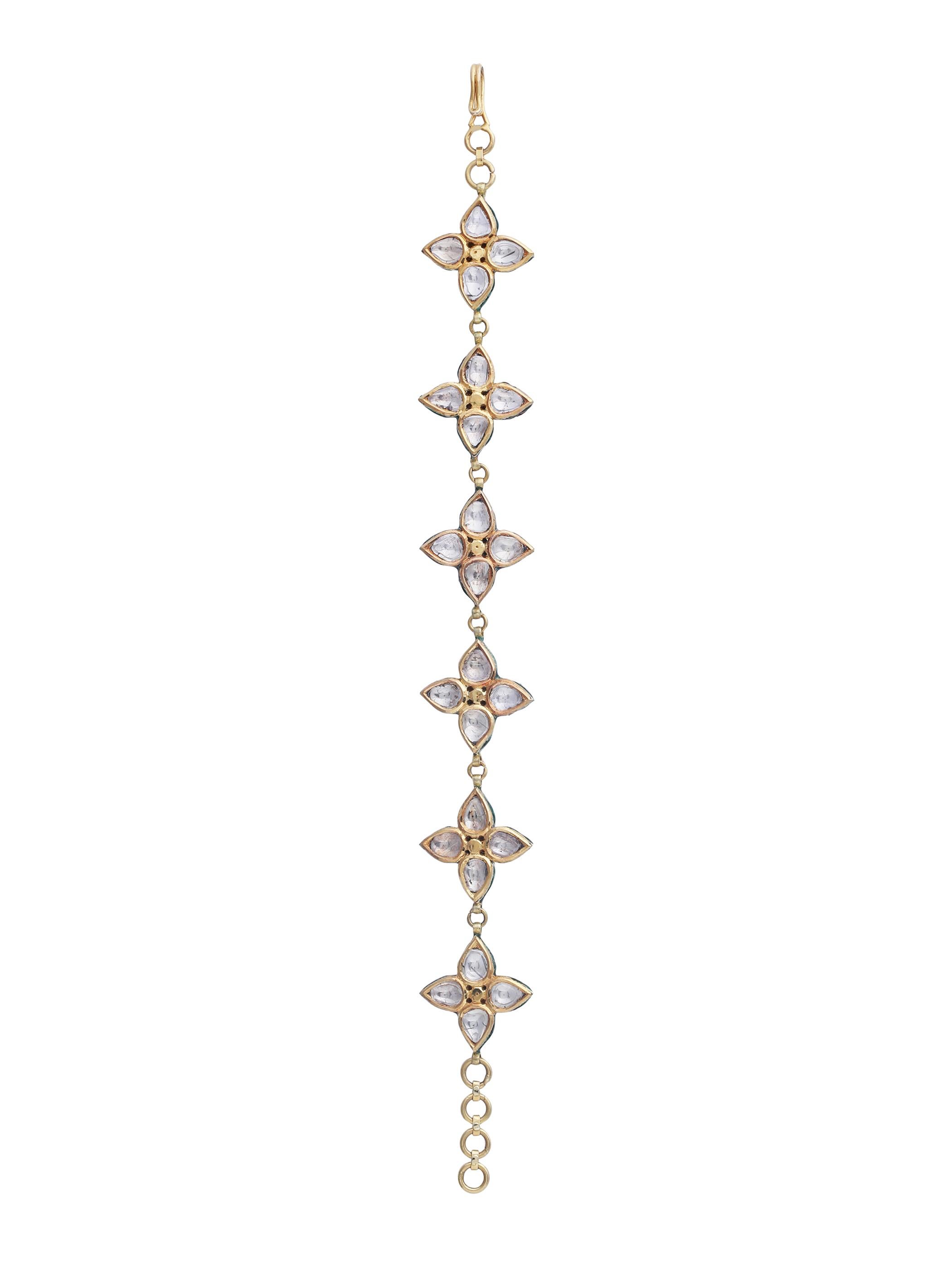 The beautiful piece handmade in 18k gold encrusted with uncut diamonds is craftsmanship at its best.
With intricate enamel at the back, the chain bracelet has six pieces of a floral motif. The jewellery piece has been designed to be adjustable and