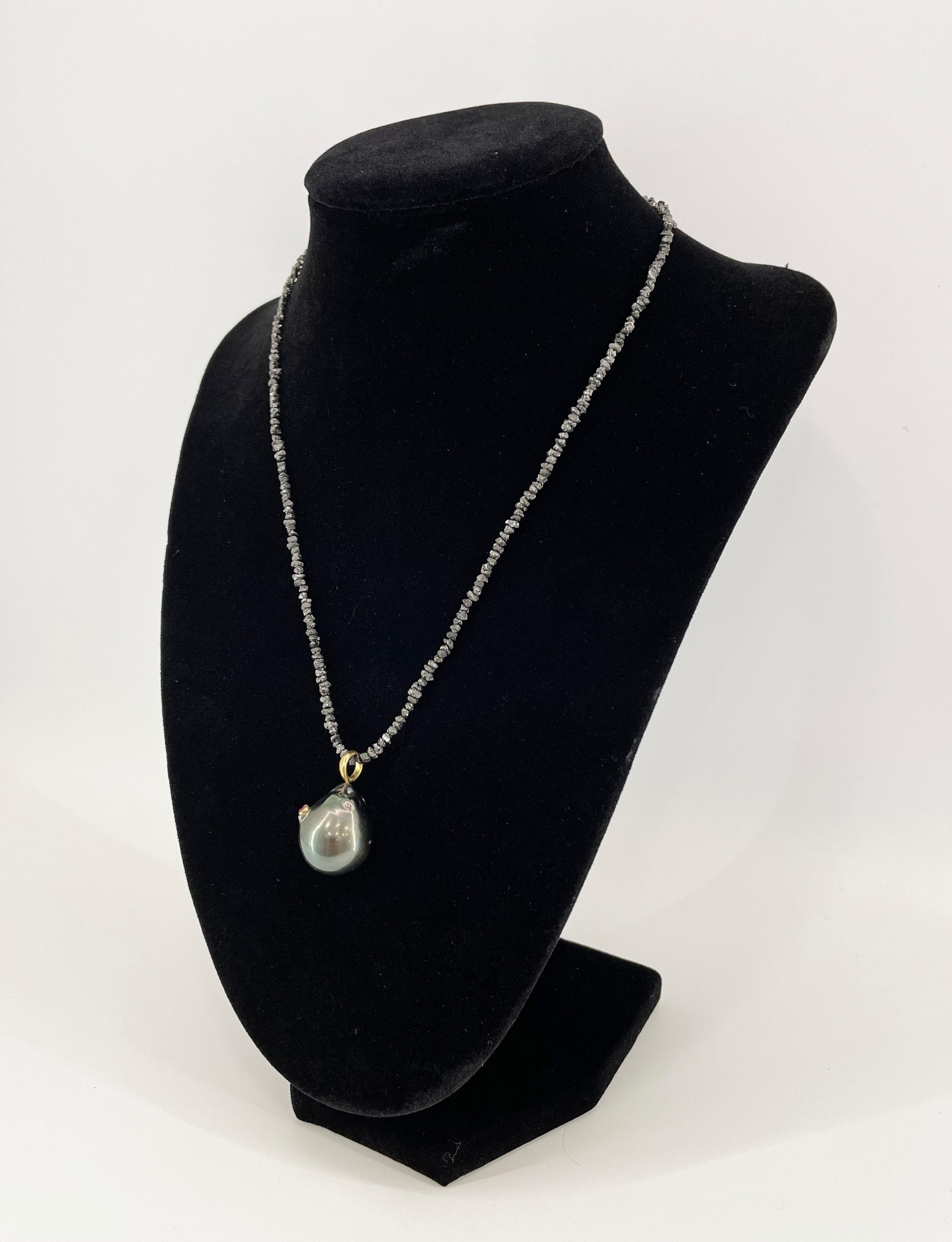 This handcrafted necklace is an impressive piece of art. 
A dark baroque pearl decorated with gold and sapphire, set in a necklace of uncut diamonds, will envelop its owner with exclusive luxury.

The baroque pearl and uncut diamonds' collar give