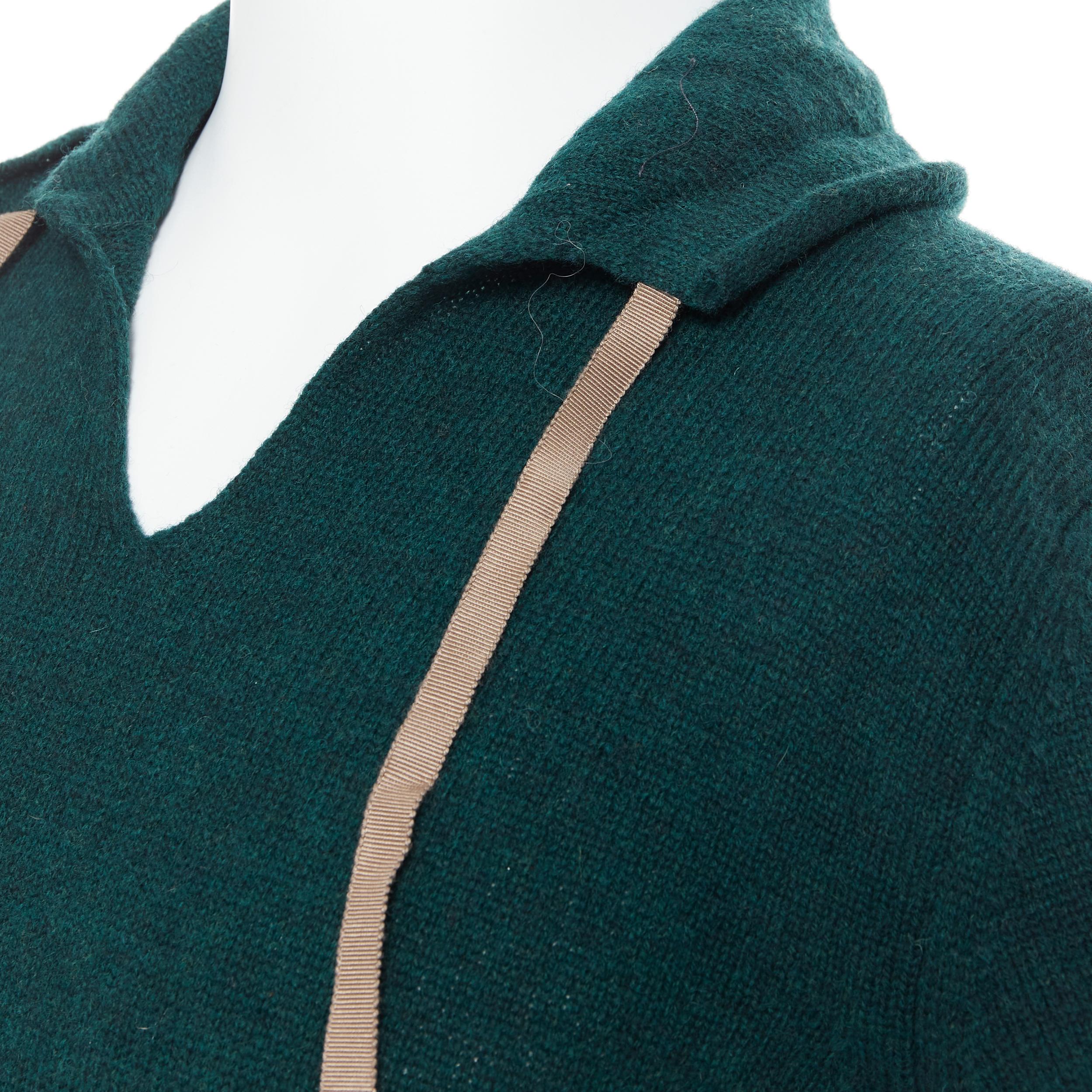 UNDERCOVER 100% wool dark green ribbon drawstring V-neck pullover sweater S 
Reference: PRCN/A00084 
Brand: Undercover 
Material: Wool 
Color: Green 
Pattern: Solid 
Extra Detail: 100% wool. V-neck. Ribbon drawstring. Kangaroo pockets. 
Made in: