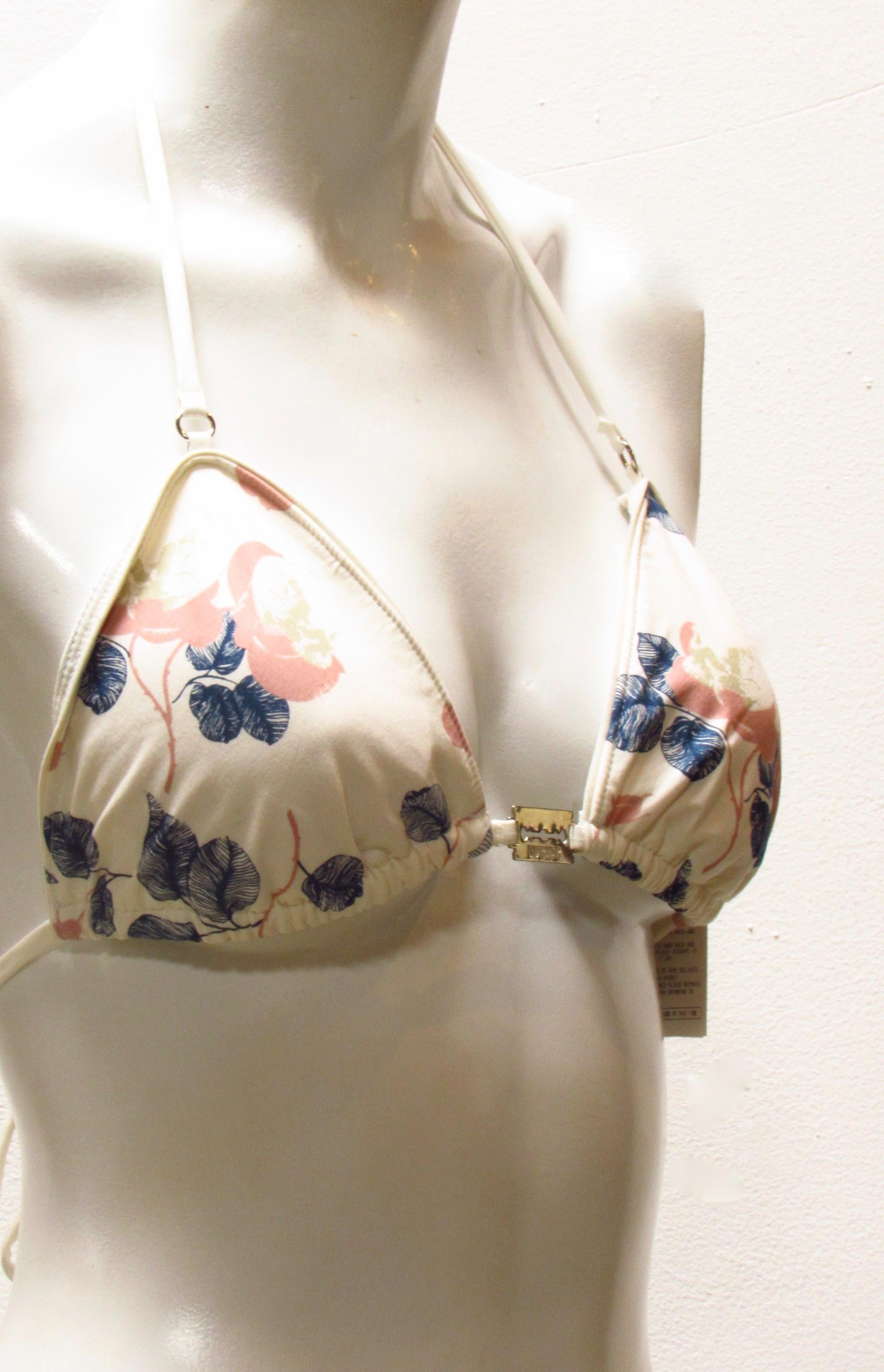 Cream colored printed string bikini from Undercover with brass buckles. 