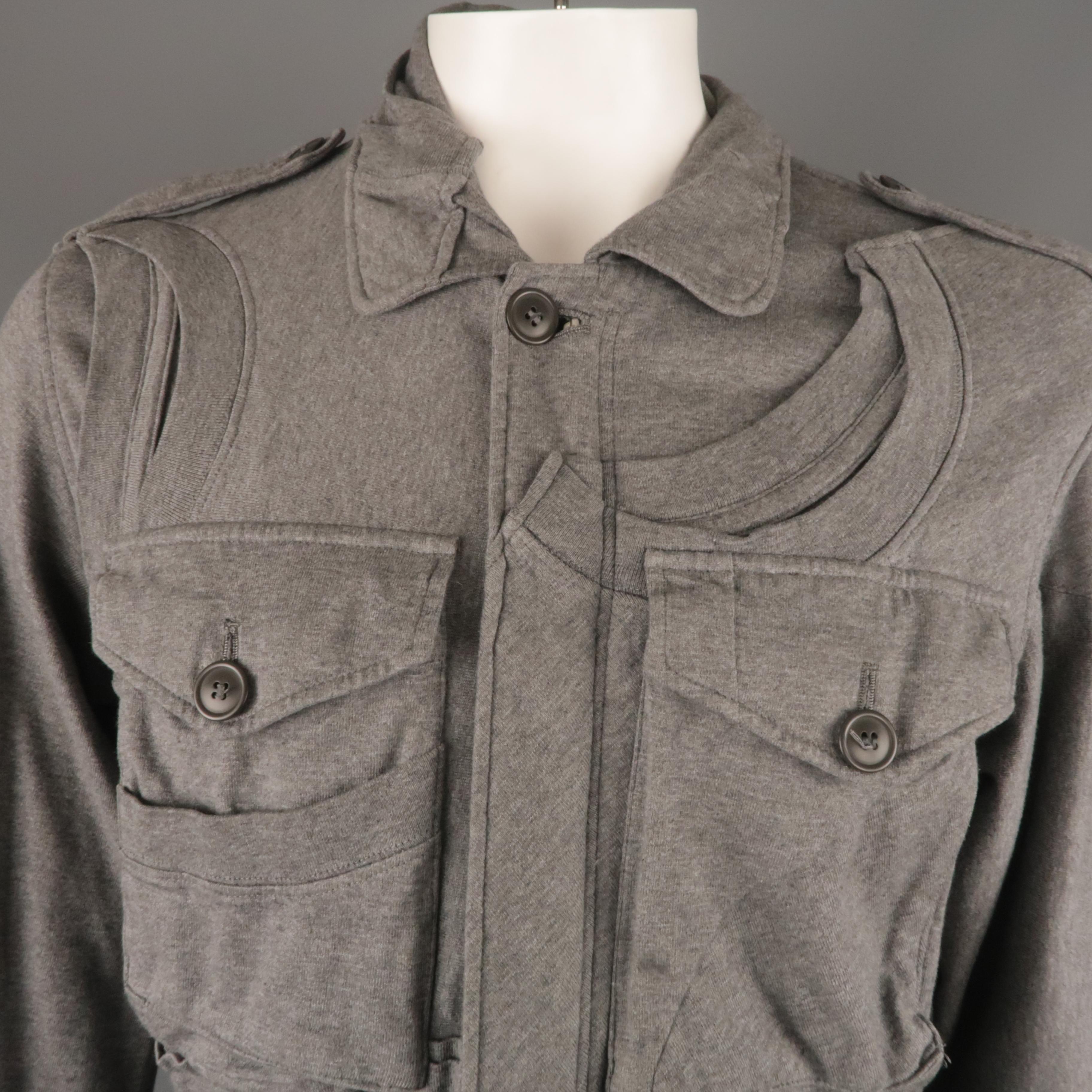UNDERCOVER jacket comes in a gray cotton featuring constructed t-shirt details, waist drawstring, and patch pockets. Made in Japan.
 
Excellent Pre-Owned Condition.
Marked: JP 3
 
Measurements:
 
Shoulder: 19 in.
Chest: 43 in.
Sleeve: 27.5