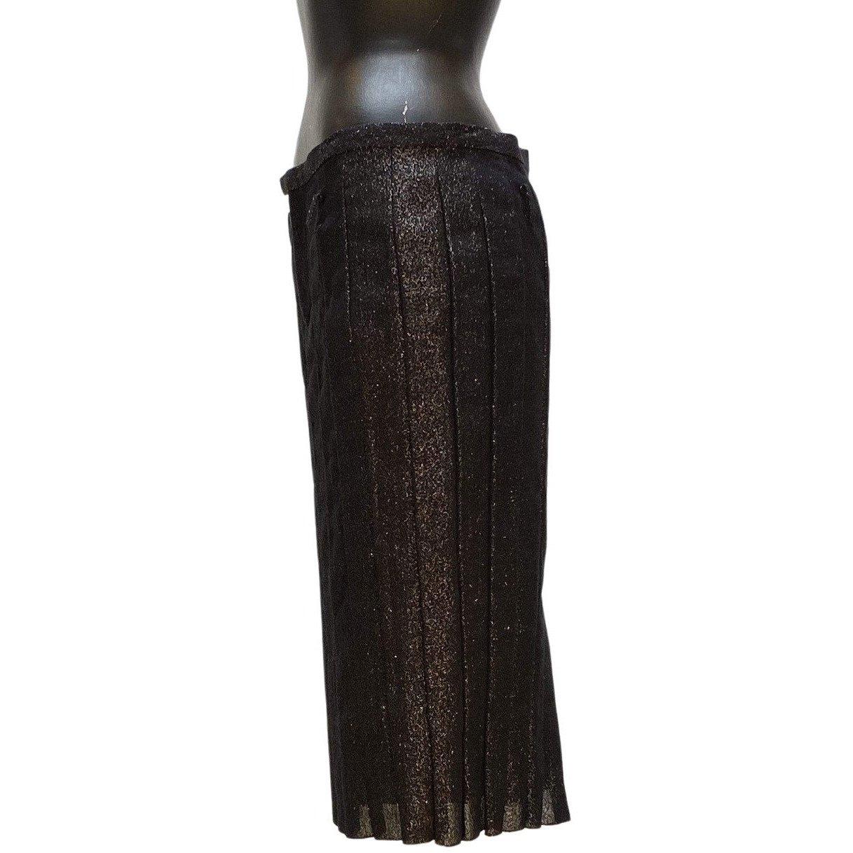 Stunning pencil skirt comes from vintage Undercover. The gentle pleats of this knee length pencil skirt are unique, but the shimmering metallic black blend of linen and cotton is what truly sets it apart. It has a zip front and a single back pocket.
