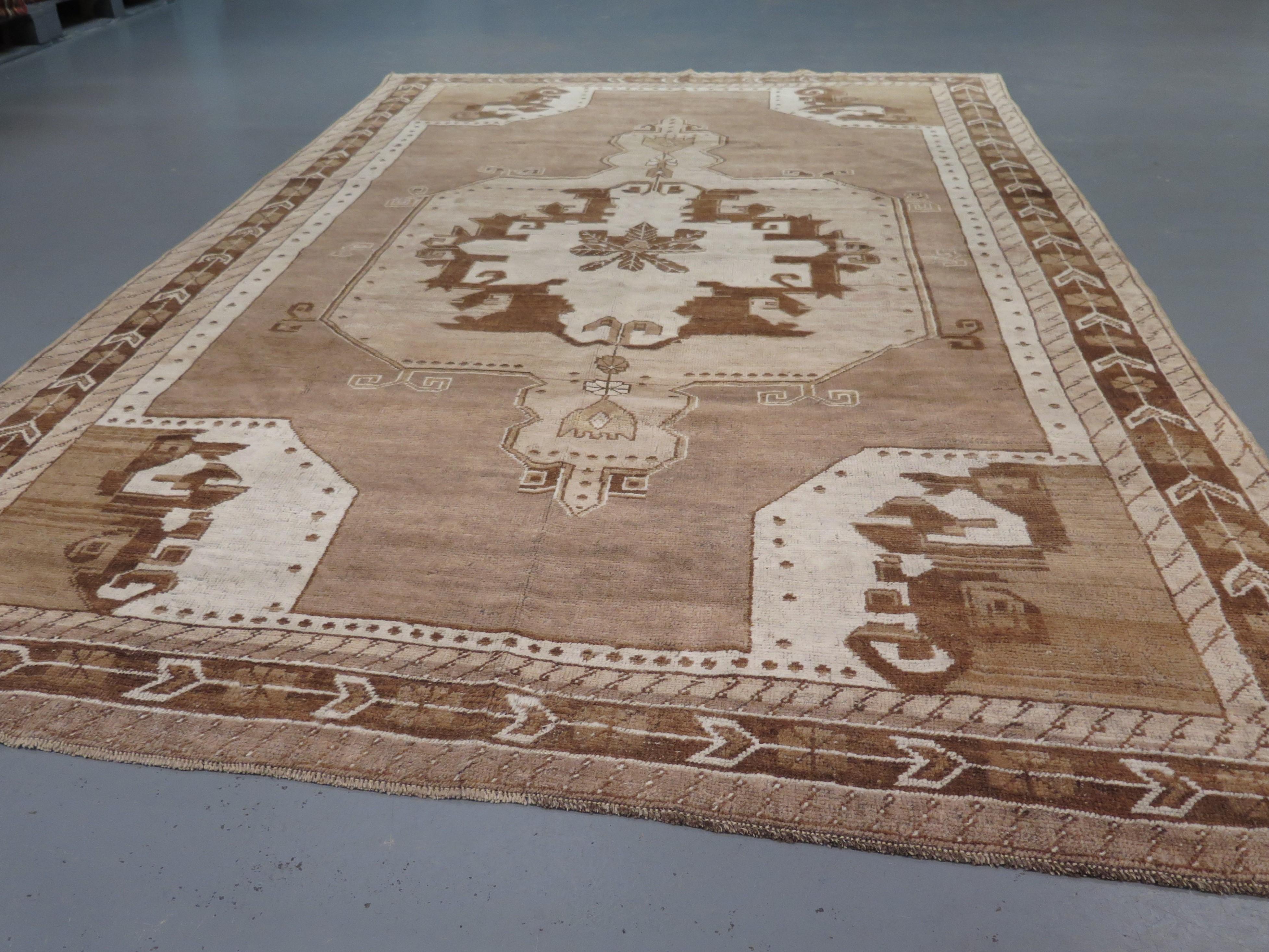 A charming early 20th Century Anatolian carpet with a simple design, woven with naturally undyed wool, in colours including ivory, caramel and muted brown.  These earthy tones have a subtle colour variation which adds a great sense of depth and