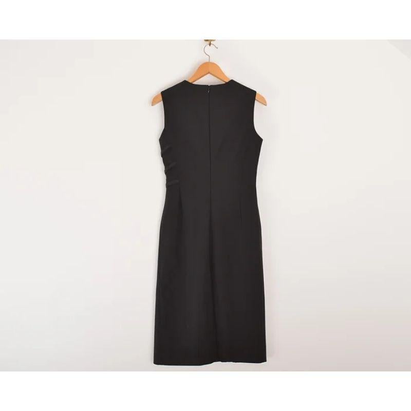 Understated 2000's Prada long shift dress, constructed from typical black PRADA nylon material, featuring tactical style buckle component details. 

Features:
Rounded neckline
Fitted shape
Slit on both front & back
Concealed zip up back
Prada