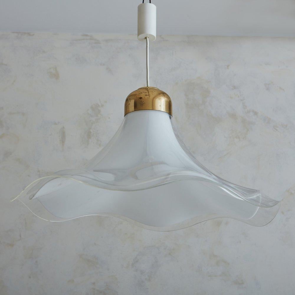 A 1970s Italian pendant light featuring a white acrylic shade with an undulated edge, which has an overlaid clear acrylic shade. This elegant pendant retains its original patinated brass dome socket cover and hangs from a white cord with a new brass