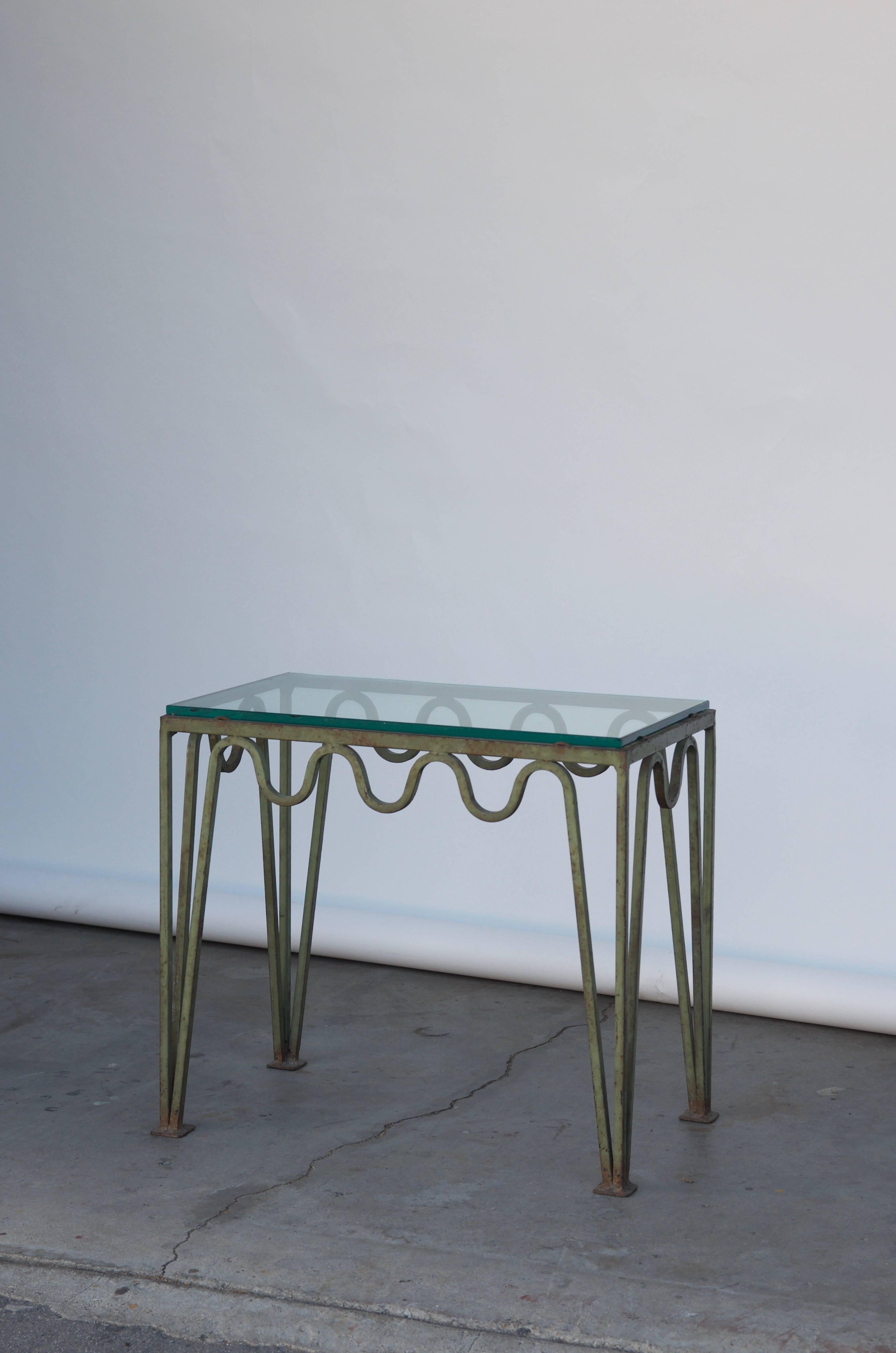 Undulating 'Méandre' verdigris iron and glass side table by Design Frères.

Chic and understated.