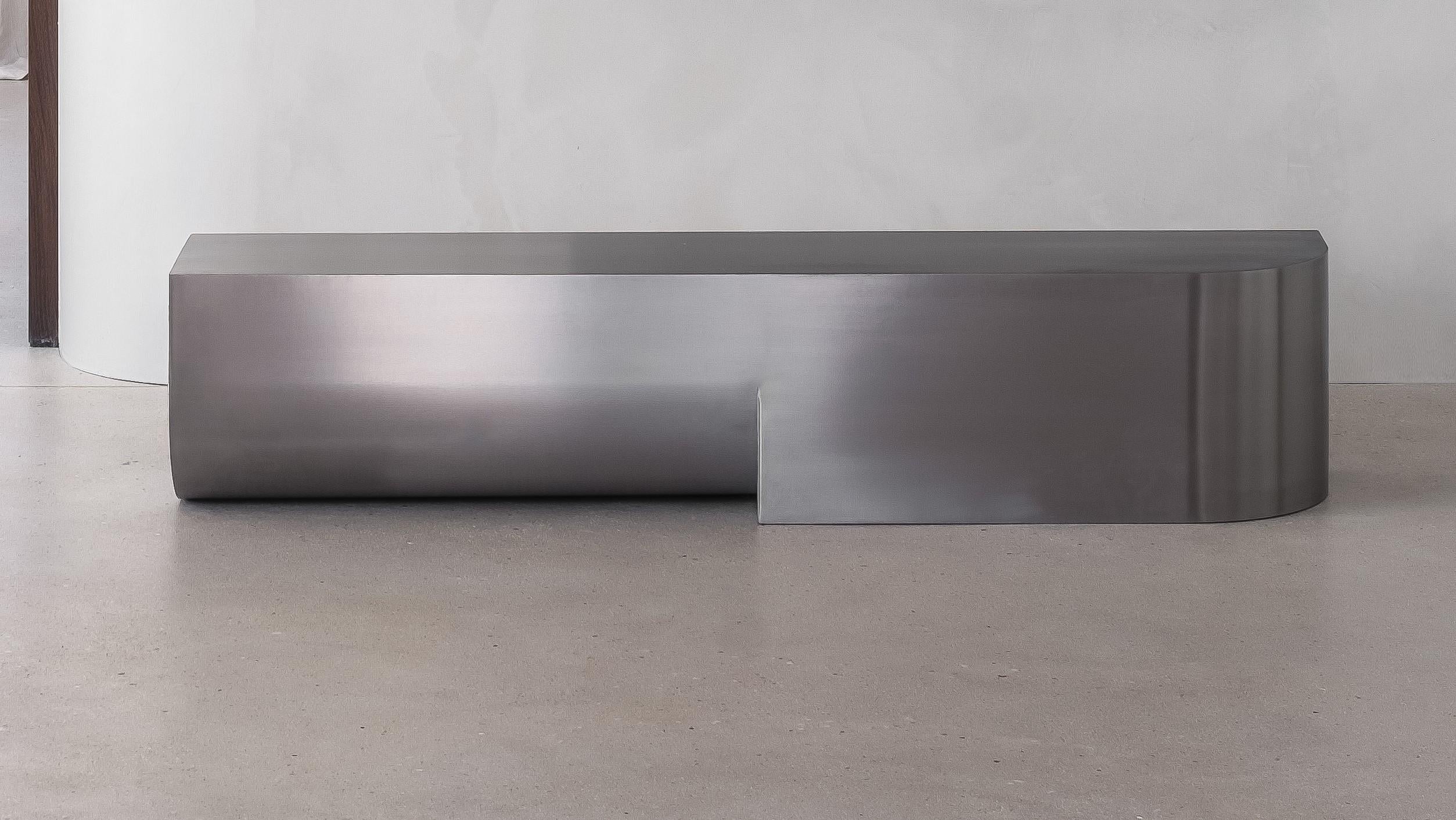 Undum Bench by ​HADGE
Dimensions: D 32 x W 150 x H 32 cm.
Materials: Brushed stainless steel.
Also available in different materials.

A cohesion of simplified curved shapes in different directions reflects the passage of passing by and reflects the