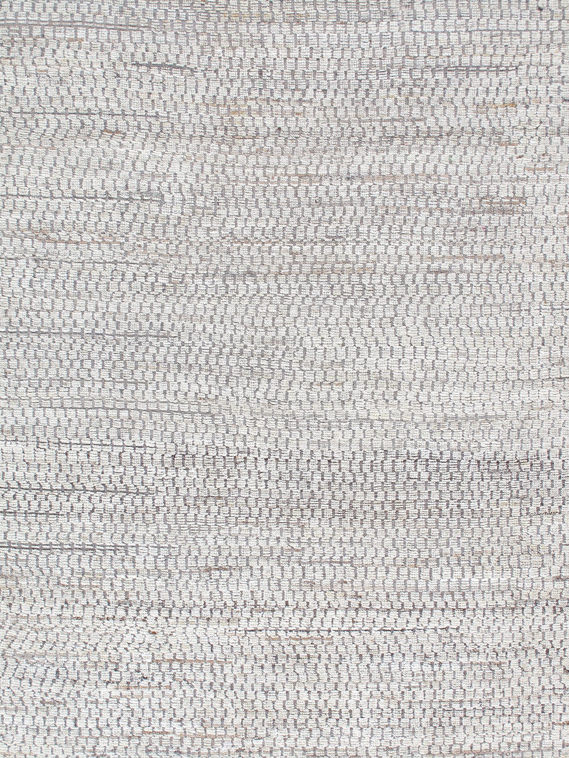 Our Relief rug is hand-knotted, and made from the finest hand-carded, hand-spun undyed wool of grey and beige tones. Many of the rugs made in the villages surrounding the city of Shiraz, are crafted by local tribal weavers, which produce many sought