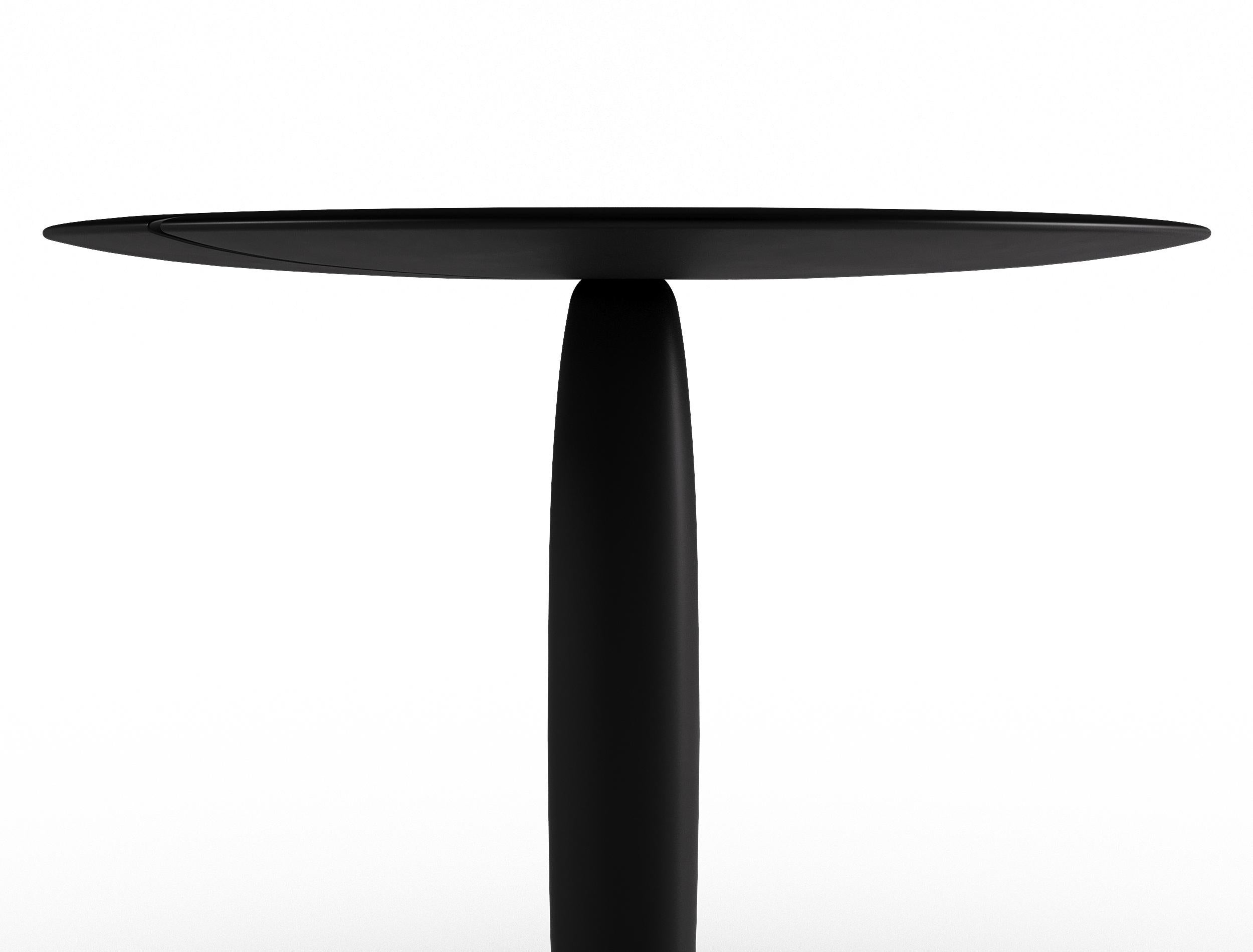Une Table à Deux is divided in two sides, compiling the individuality and togetherness to achieve a supremely elegant ambiguity.

BI-lobed wooden top supported by sculptural foot inspired from the vanilla pod. 
Solid ebonized Acacia wood plays in