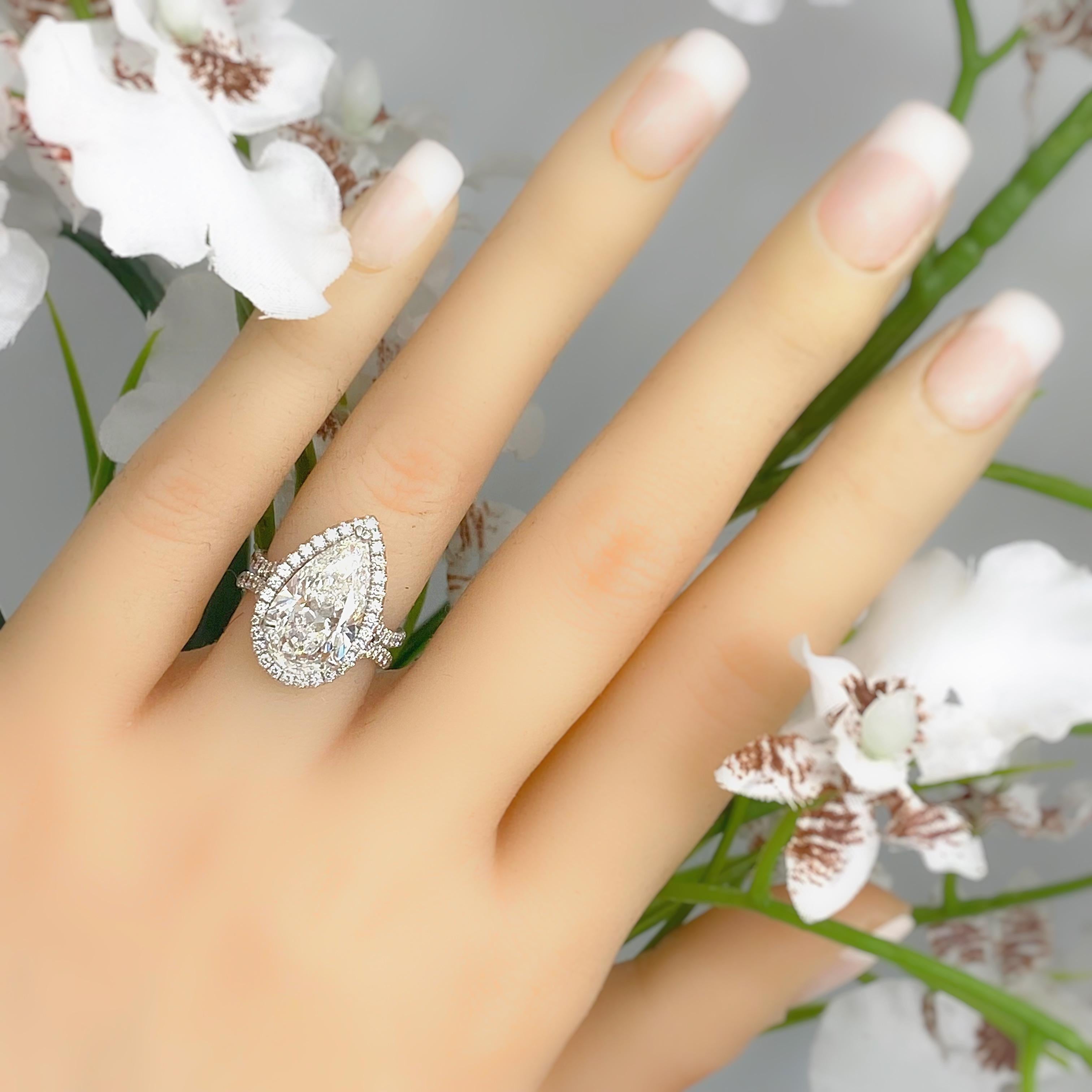 UNEEK Custom Pear Shape Diamond Halo Diamond Engagement Ring
Style:  Halo Split Shank
GIA:  1176672447
Metal:  14kt White Gold
Size:  4.5 
TCW:  5.90 tcw
Main Diamond:  Pear Shape Diamond 5.03 cts 
Color & Clarity:  E, SI1
Diamond has GIA 1176672447