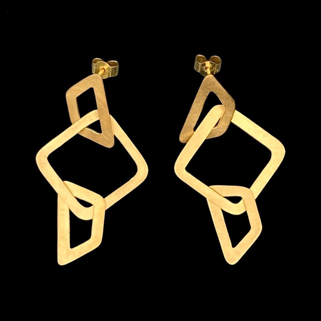 These lightweight earrings are a perfect everyday statement.

They are fabricated from sterling silver sheet, and are finished with a matte sheen with burnished shiny edges to catch the light when worn. They are plated in rich 18ct Yellow gold,