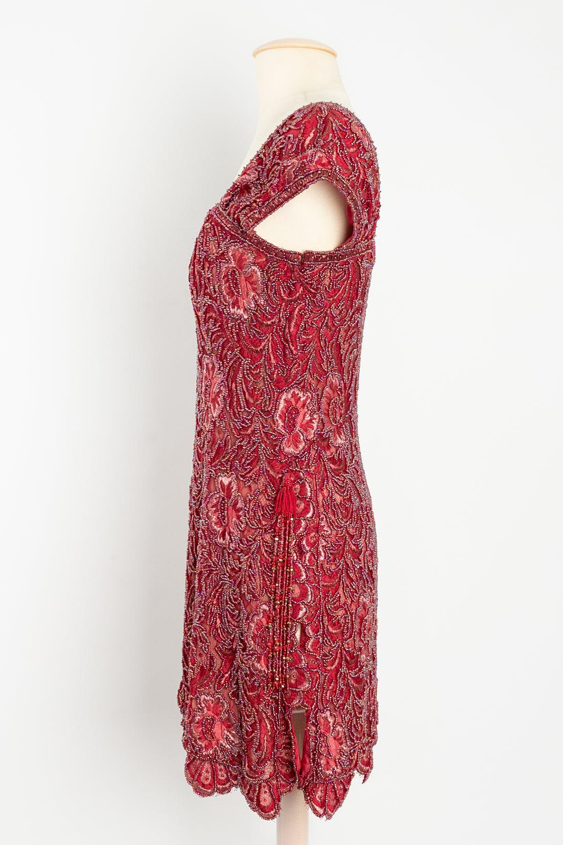 Ungaro-Emanuel Ungaro Couture - Paris Bolduc: 3194-5-94 Dress composed of three red and beige silk linings fully embroidered with red beads, woven threads and raffia in a foliage and flower pattern. No size label shown, fits a 36FR.

Additional