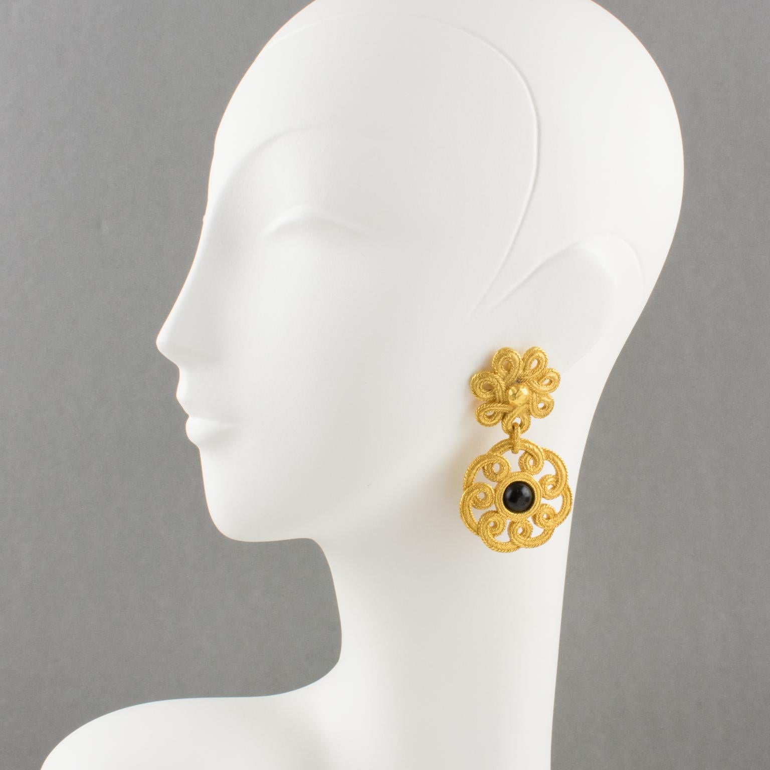 Elegant Emanuel Ungaro Paris signed clip-on earrings. Gilt metal floral dangling shape all textured and see-thru, topped with black resin cabochon. Signed with tag underside 