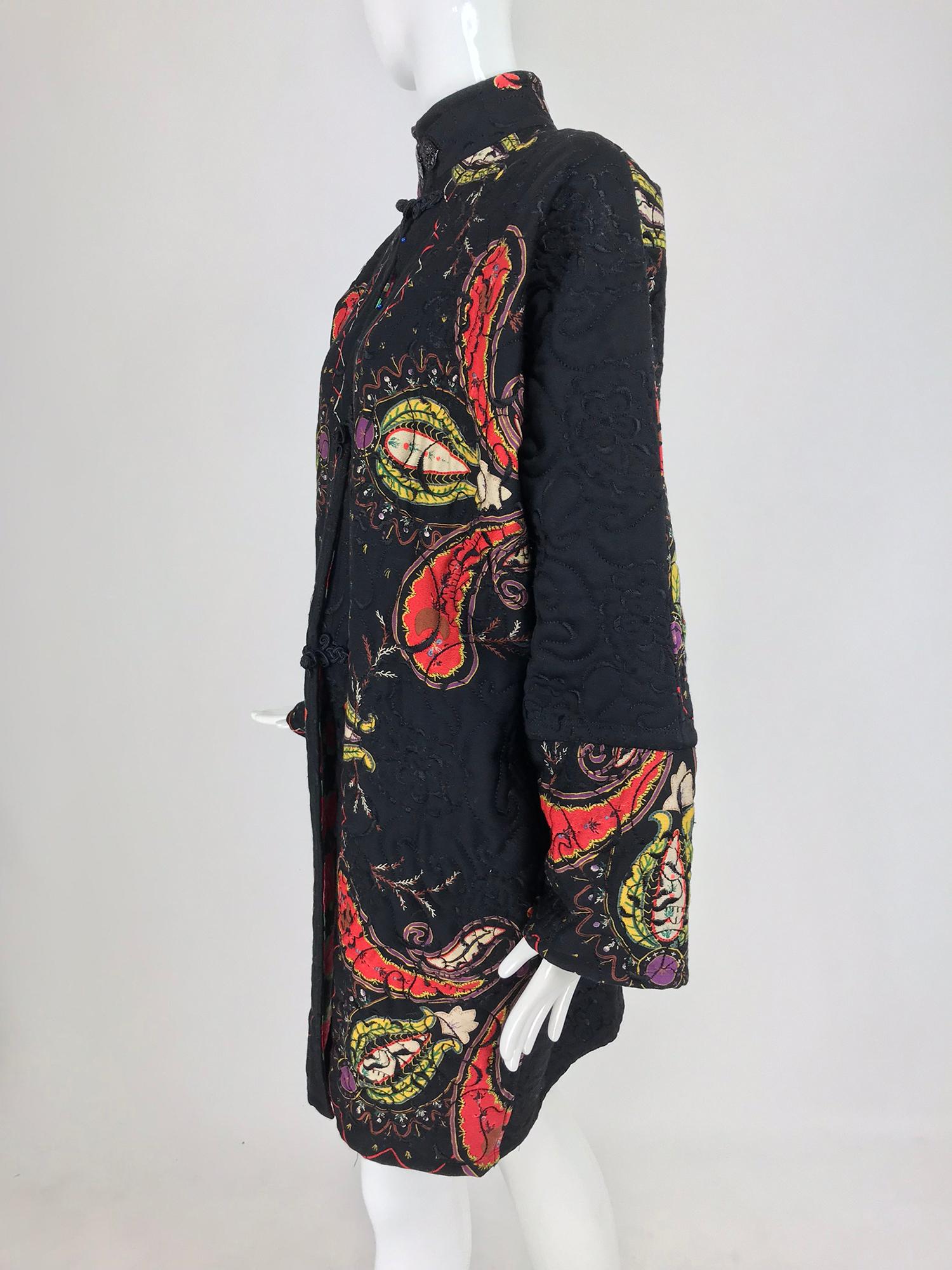 Ungaro Parallele applique quilted coat from the 1980s. This coat has a bohemian vibe with a chic touch lent by Ungaro. The quilted coat has raglan sleeves that taper to the wrist, on seam side pockets. Semi full through the body, it tapers to the