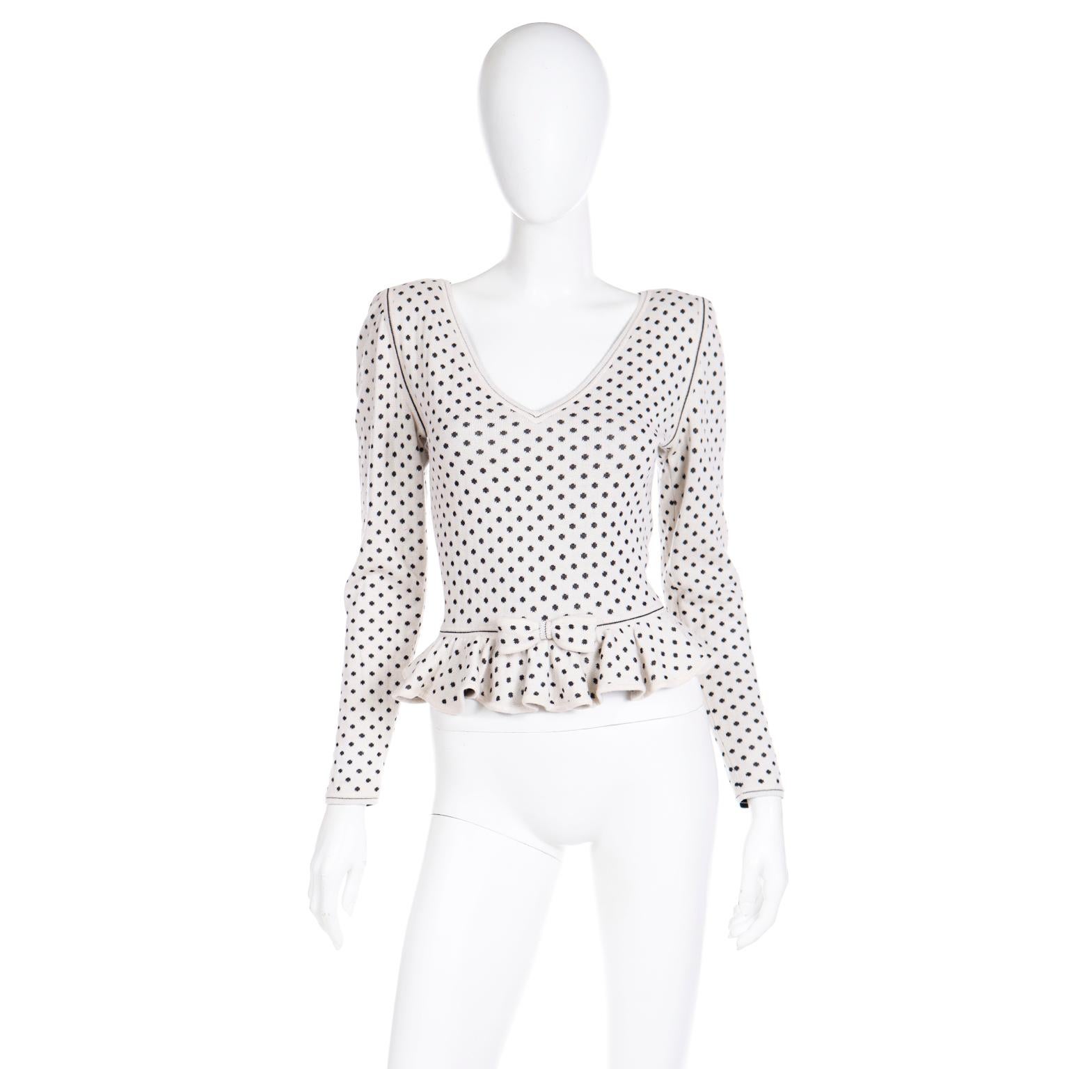 We love vintage Ungaro and we were so happy to find this beautiful cashmere blend sweater! This vintage deadstock Ungaro Parallele Paris v neck top is in a soft white with black polka dots. The top has pretty black seams at the armscyes and waist,