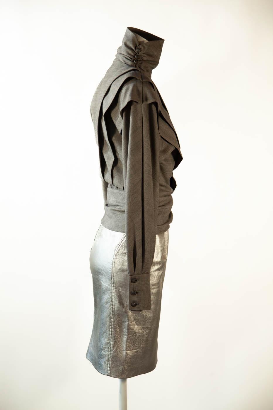 Ungaro Parallele Paris wool blend blouse and leather skirt. Blouse with sculptural design, grey, long balloon sleeves with cavalier cuffs.  Measures: Bust 36