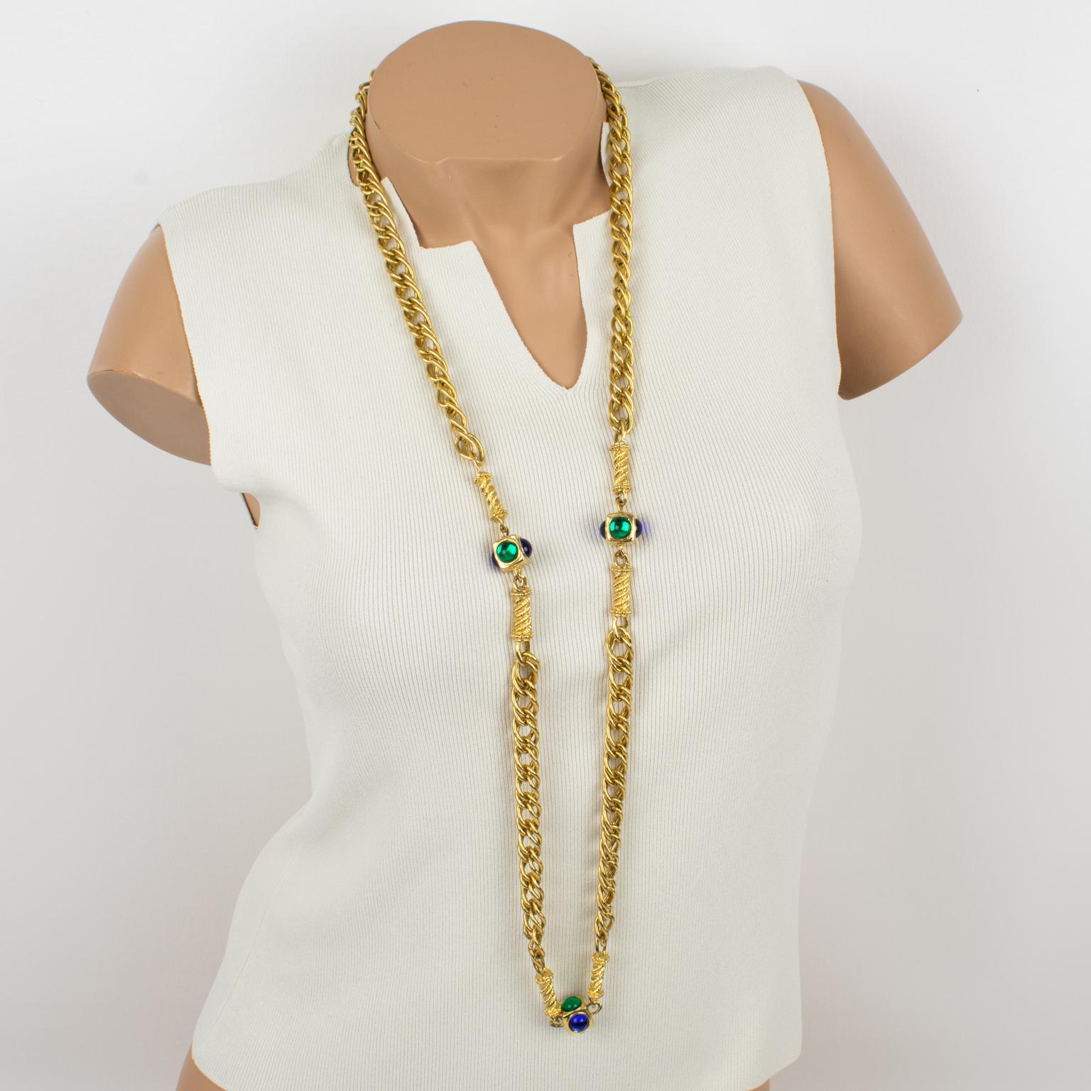 This couture Ungaro Paris long necklace features a heavy satin gilded metal chain, ornate with square elements, topped with cobalt blue and emerald green resin cabochons. The necklace has no clasp and can be easily slipped over the head due to its