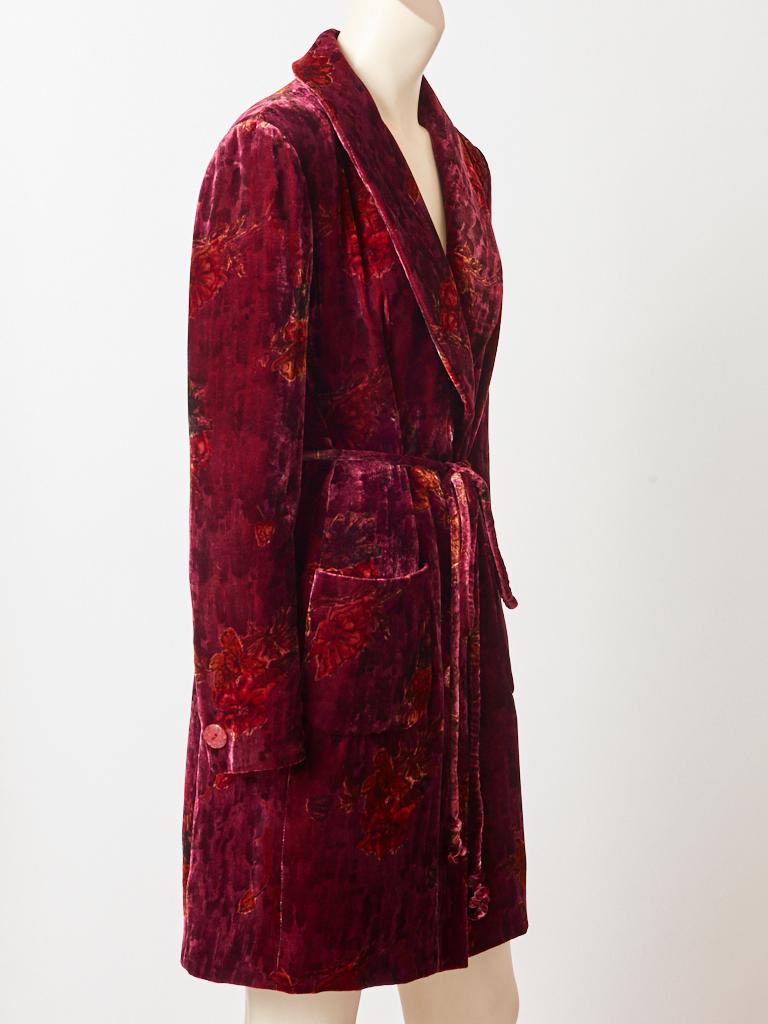 Emanuel Ungaro, burgundy, printed velvet, floral pattern, belted robe/coat/dress, having a shawl collar, 
large patch pockets and a tubular self belt.  