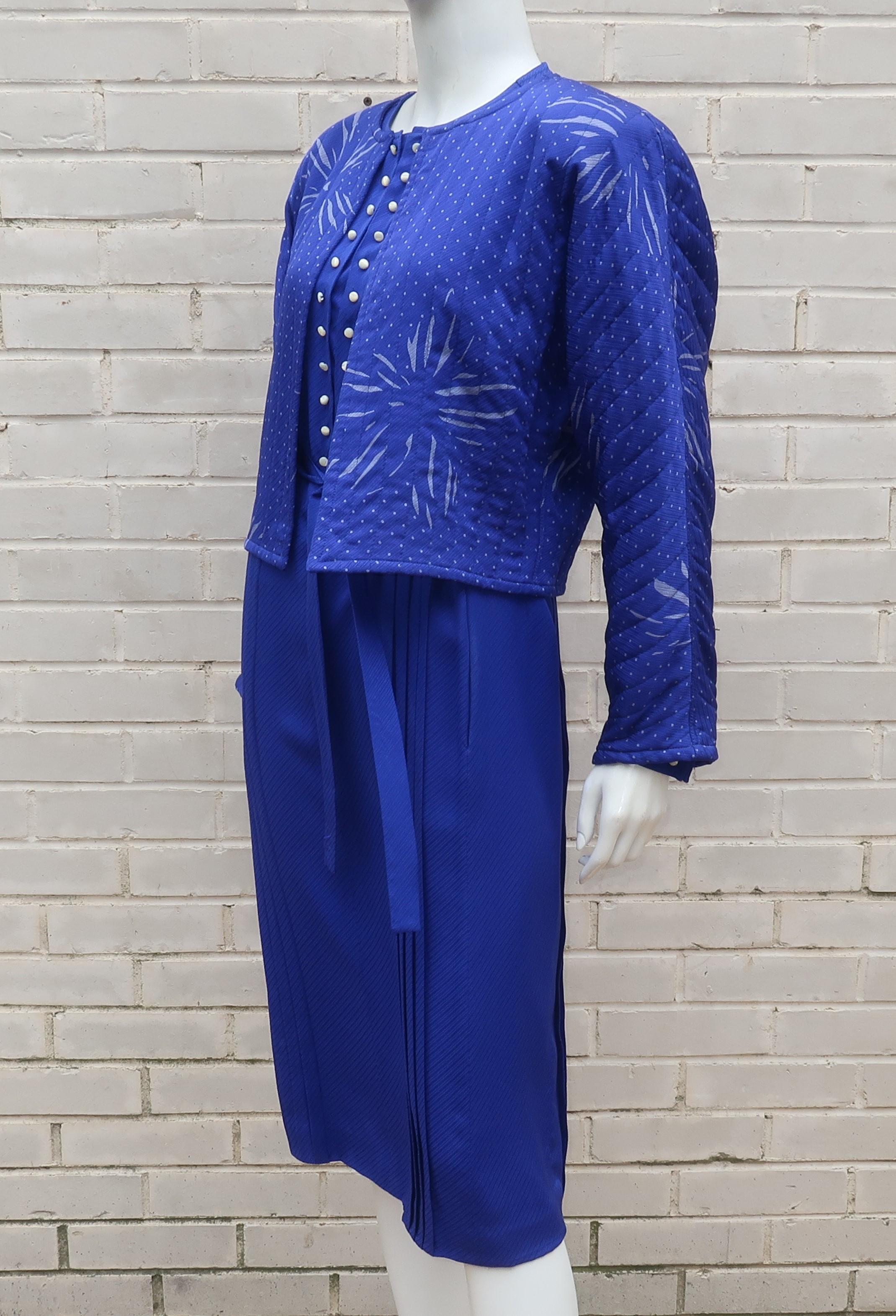 C.1980 Emanuel Ungaro royal blue silk shift dress with coordinating cropped quilted jacket with a celestial style silvery gray print.  The dress has a pullover construction with hidden snaps at the front panel which is also decorated with rows of