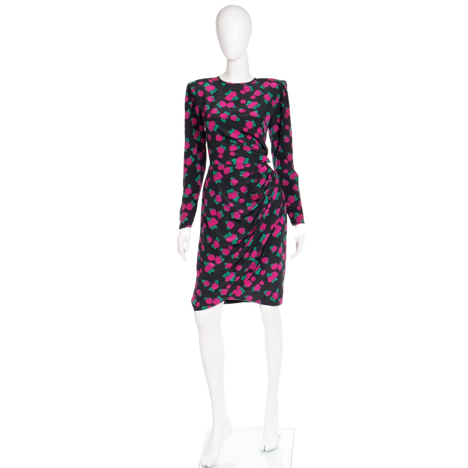 This pretty vintage Ungaro black silk dress features magenta pink flowers in a faux wrap style. We always love it when dresses have side ruching, as it is so flattering and creates a lovely silhouette. This is the perfect dress to wear to a special