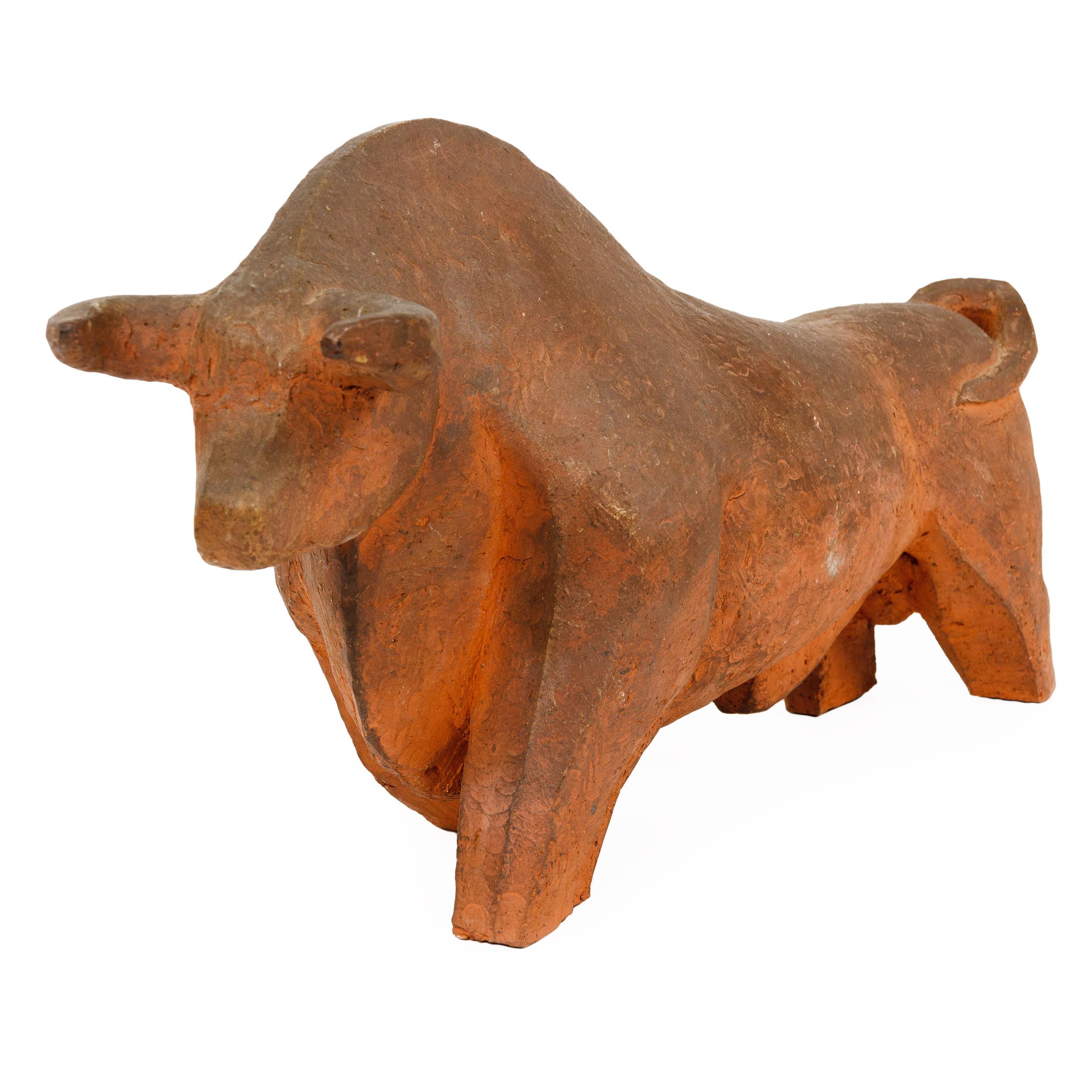 An unglazed decorative earthenware ceramic bull sculpture, circa 1960s.
