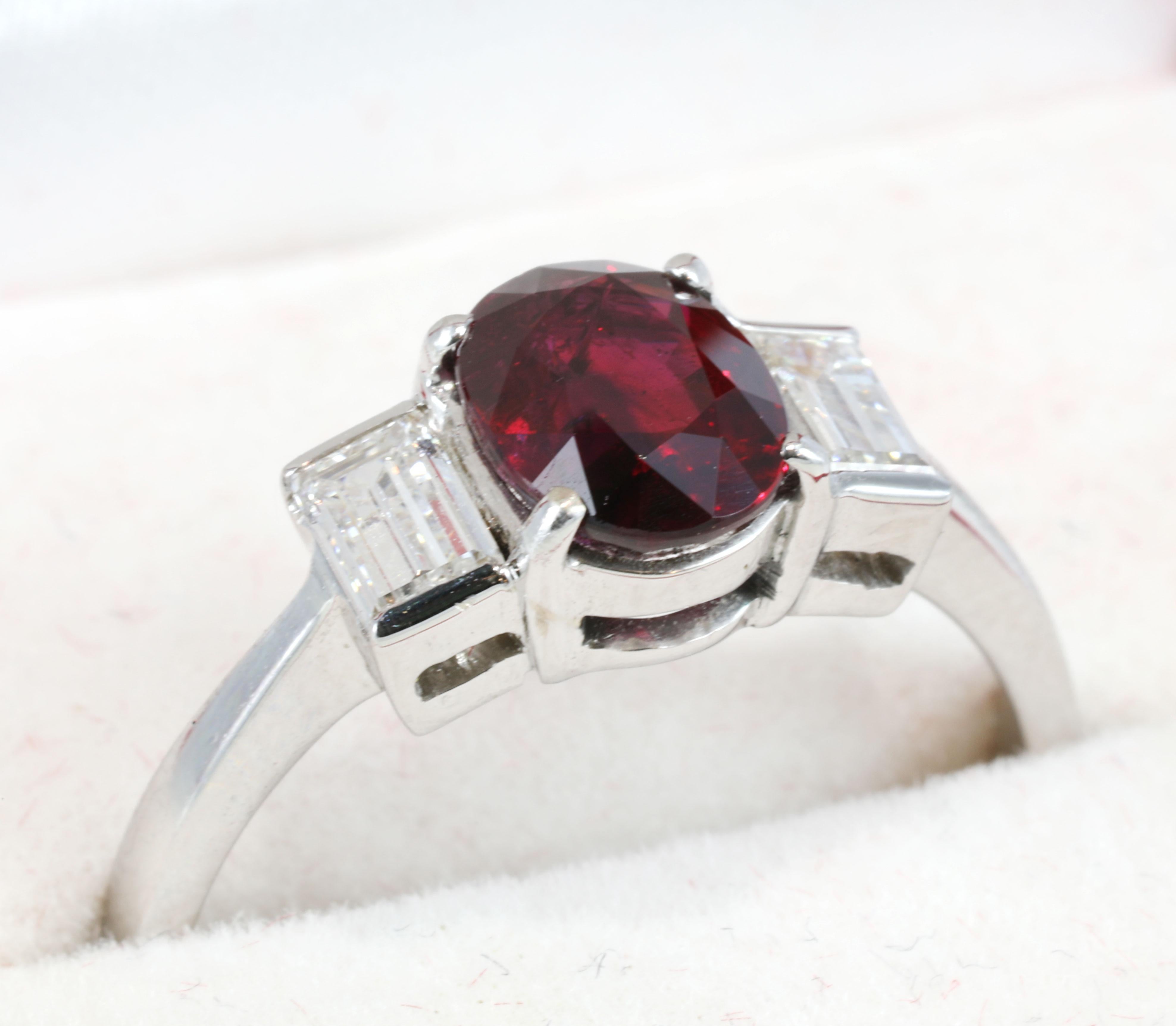 Unheated 1.54 Carat “Pigeon’s Blood” Burmese Ruby & Diamond 18K Gold Ring, GIA & GRS Certified.


center stone with a client stated weight of 1.54 carats set
in a white metal ring with two (2) near-colorless
Baguettes.
The color appearance of this